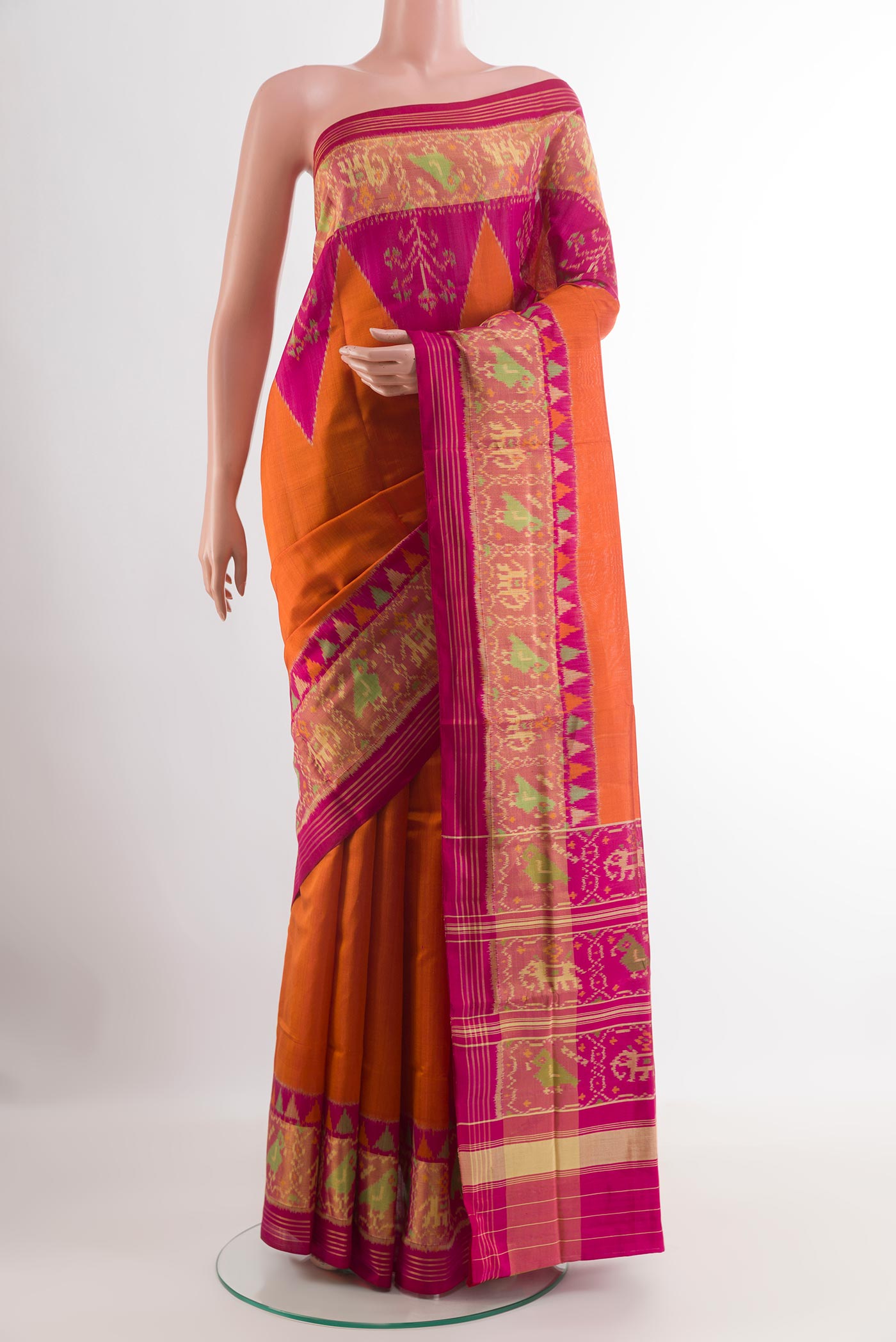 Orange Rajkot Patola Silk Saree with Pure Ikat on the body and Zari Border.  displayed on a mannequin
