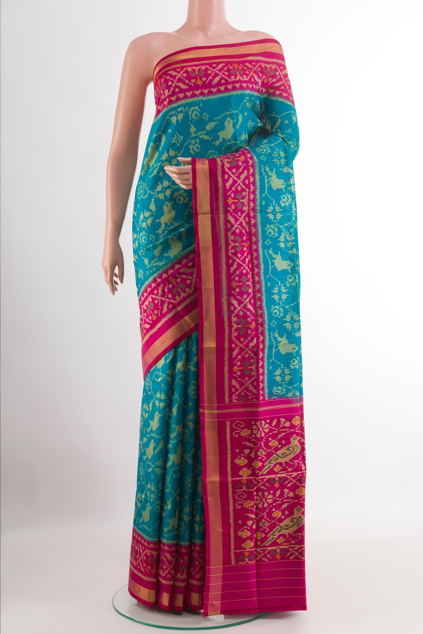 Blue Rajkot Patola Silk Saree with Pure Ikat on the body and Zari Border.  displayed on a mannequin