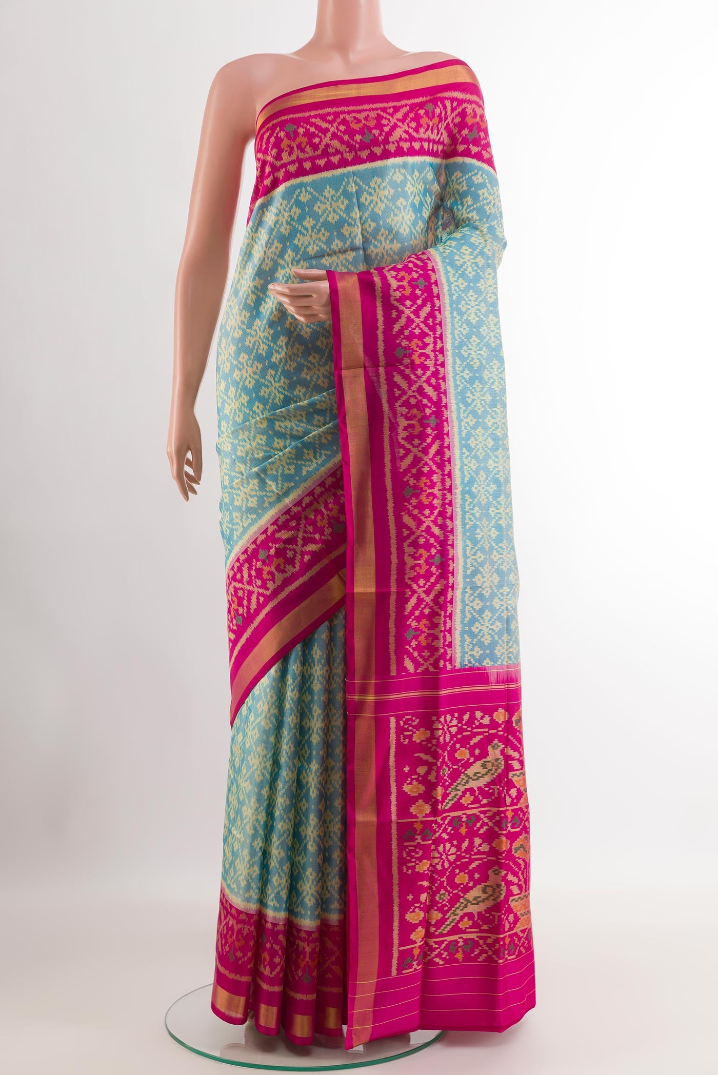 Blue Rajkot Patola Silk Saree with Ikat design on the body and Zari Border.  displayed on a mannequin