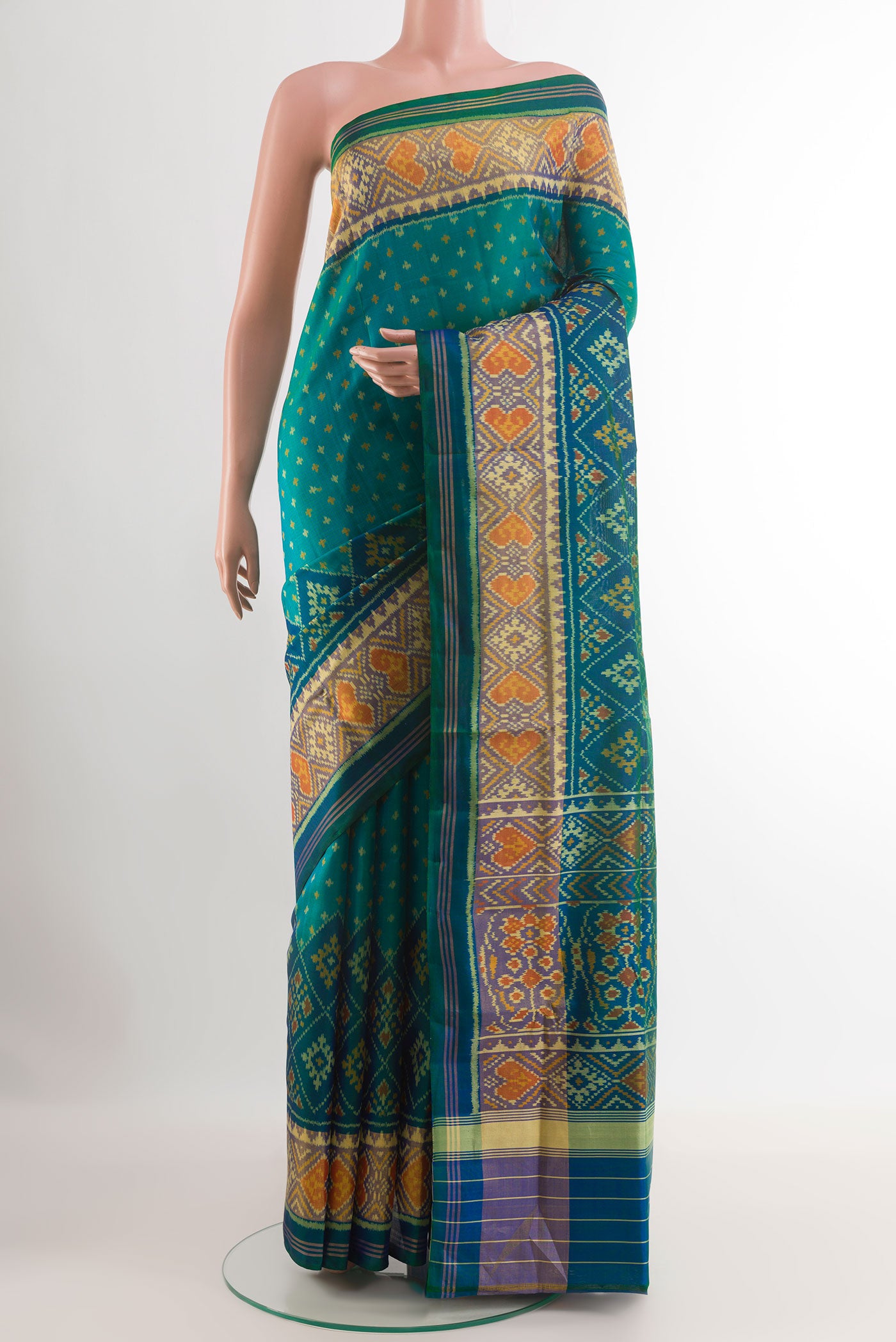 Peacock Blue Rajkot Patola Silk Saree with Pure Ikat on the body and Zari Border.  displayed on a mannequin