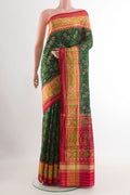 Green Rajkot Patola Silk Saree with Pure Ikat on the body and Zari Border.  displayed on a mannequin