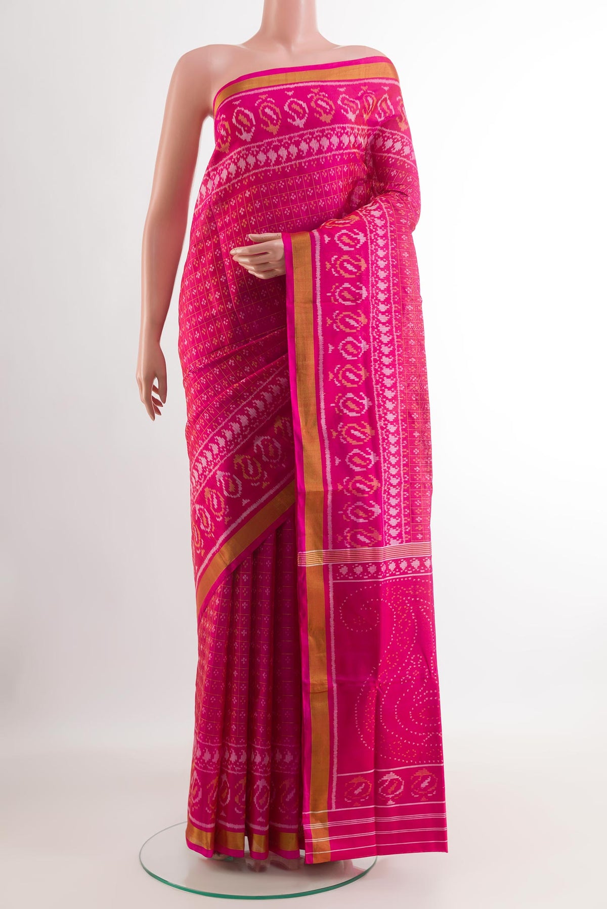 Pink Rajkot Patola Silk Saree with Ikat design on the body and Zari Border.  displayed on a mannequin