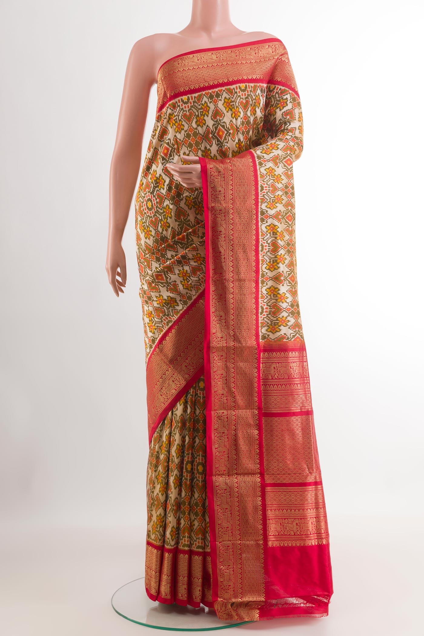 Off White Pochampally Silk Saree with Ikat design on the body and Zari Border.  displayed on a mannequin
