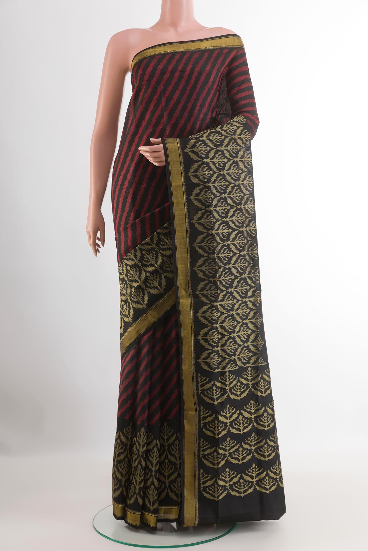 Black Rajkot Patola Silk Saree with Pure Ikat on the body and Zari Border.  displayed on a mannequin
