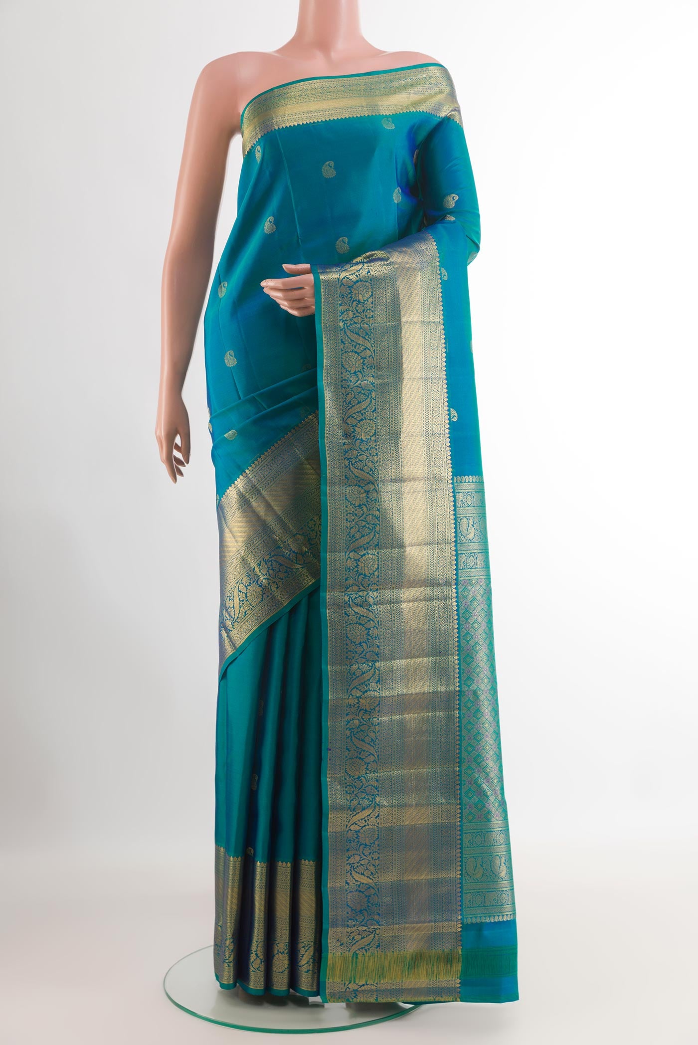 Peacock Blue Kanjivaram Silk Saree with Zari Butta on the body and Zari Border.  displayed on a mannequin