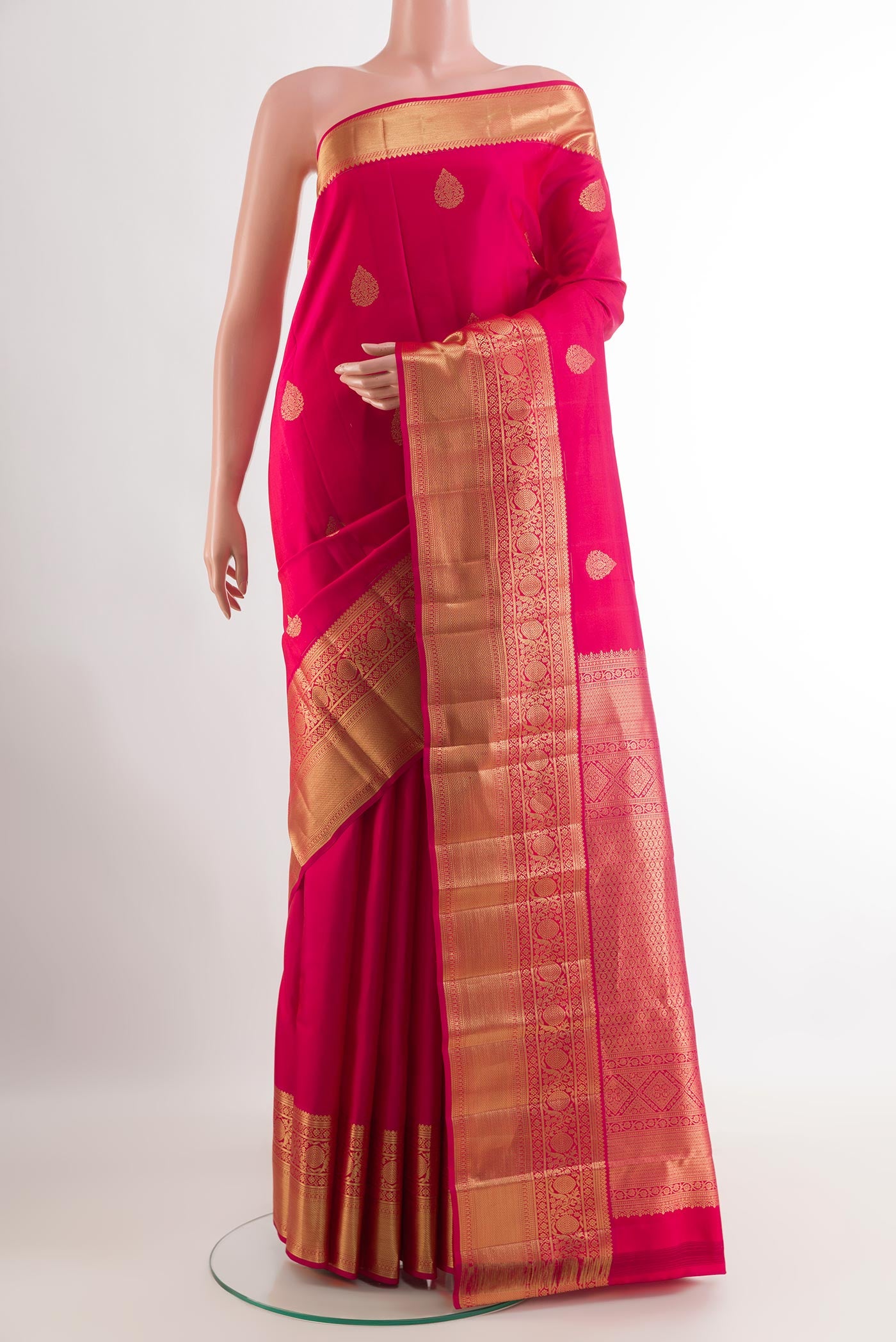 Pink Kanjivaram Silk Saree with Zari Butta on the body and Zari Border.  displayed on a mannequin