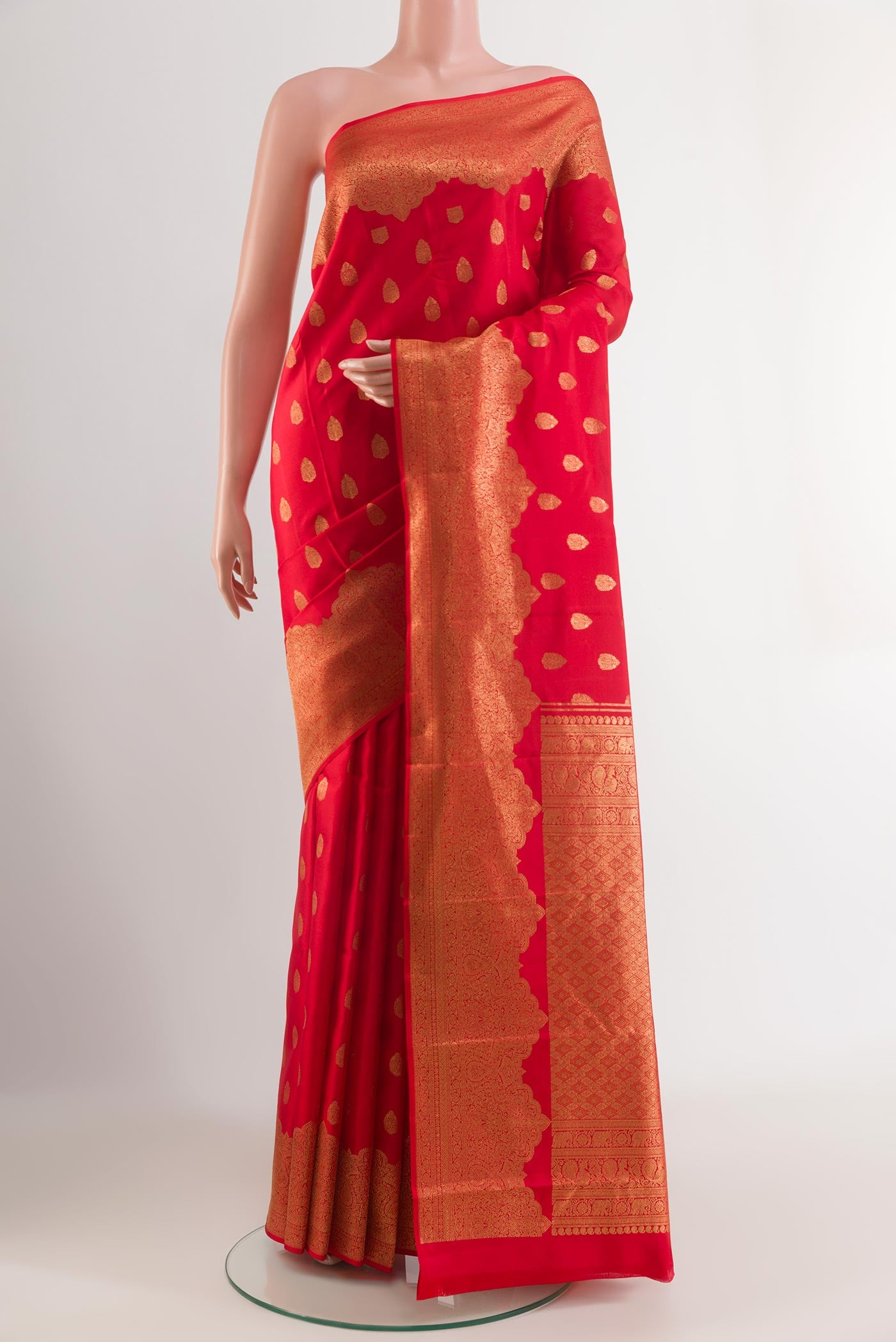 Red Kanchipuram Silk Saree with Zari Butta on the body and Zari Border.  displayed on a mannequin