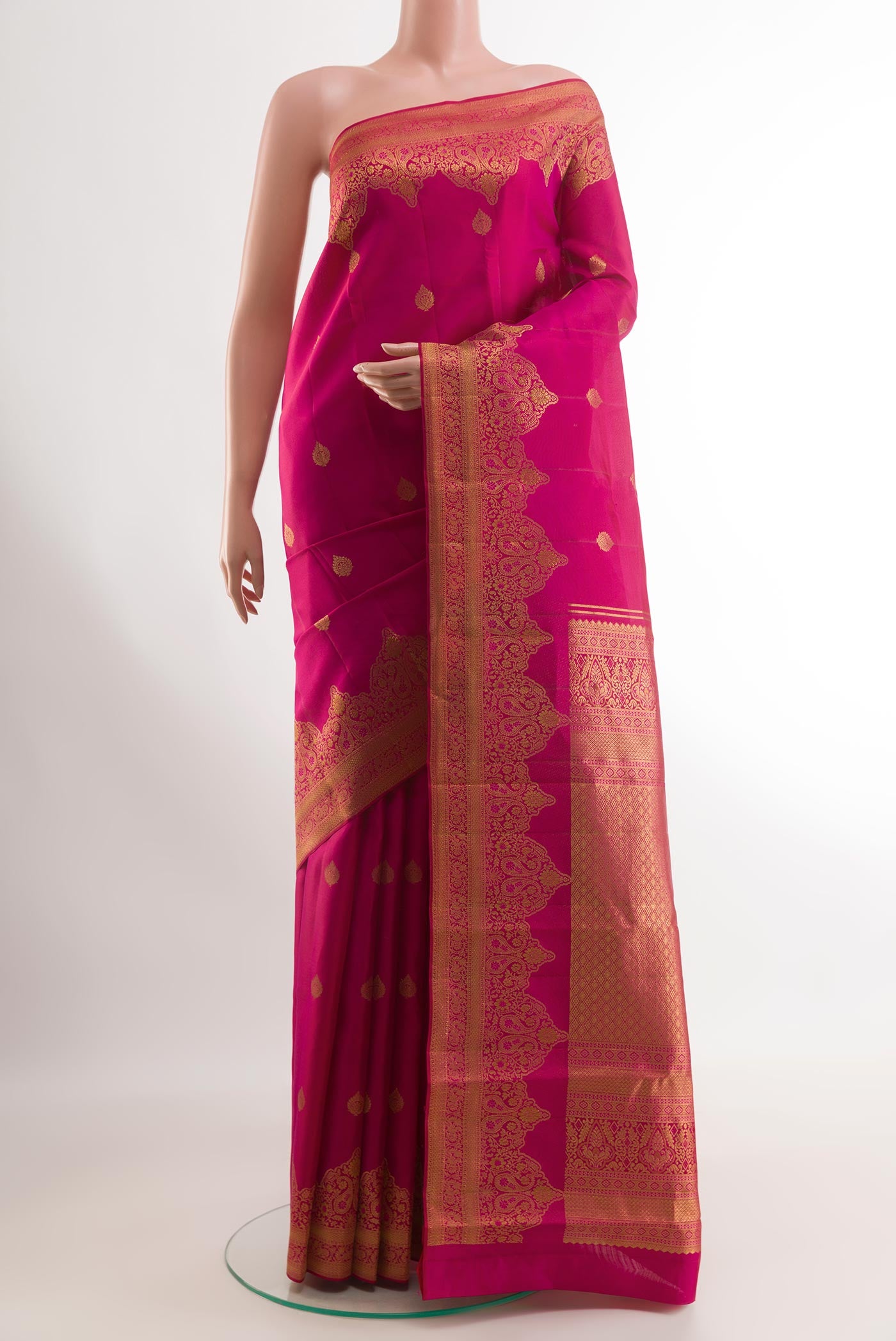 Rani Pink Kanchipuram Silk Saree with Zari Butta on the body and Zari Border.  displayed on a mannequin
