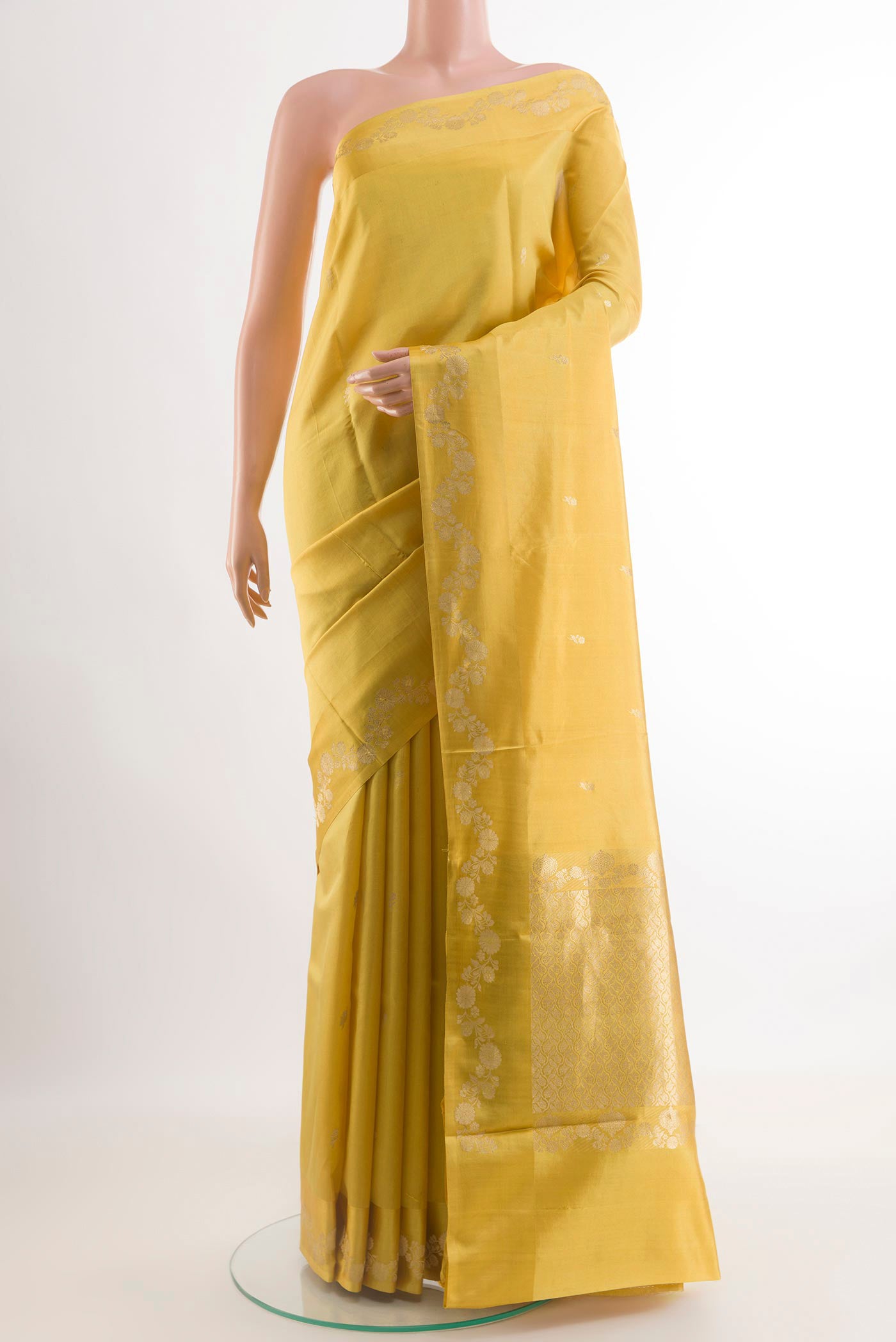 Yellow Banarasi Katan Silk Saree with Zari Butta on the body and Zari Border.  displayed on a mannequin
