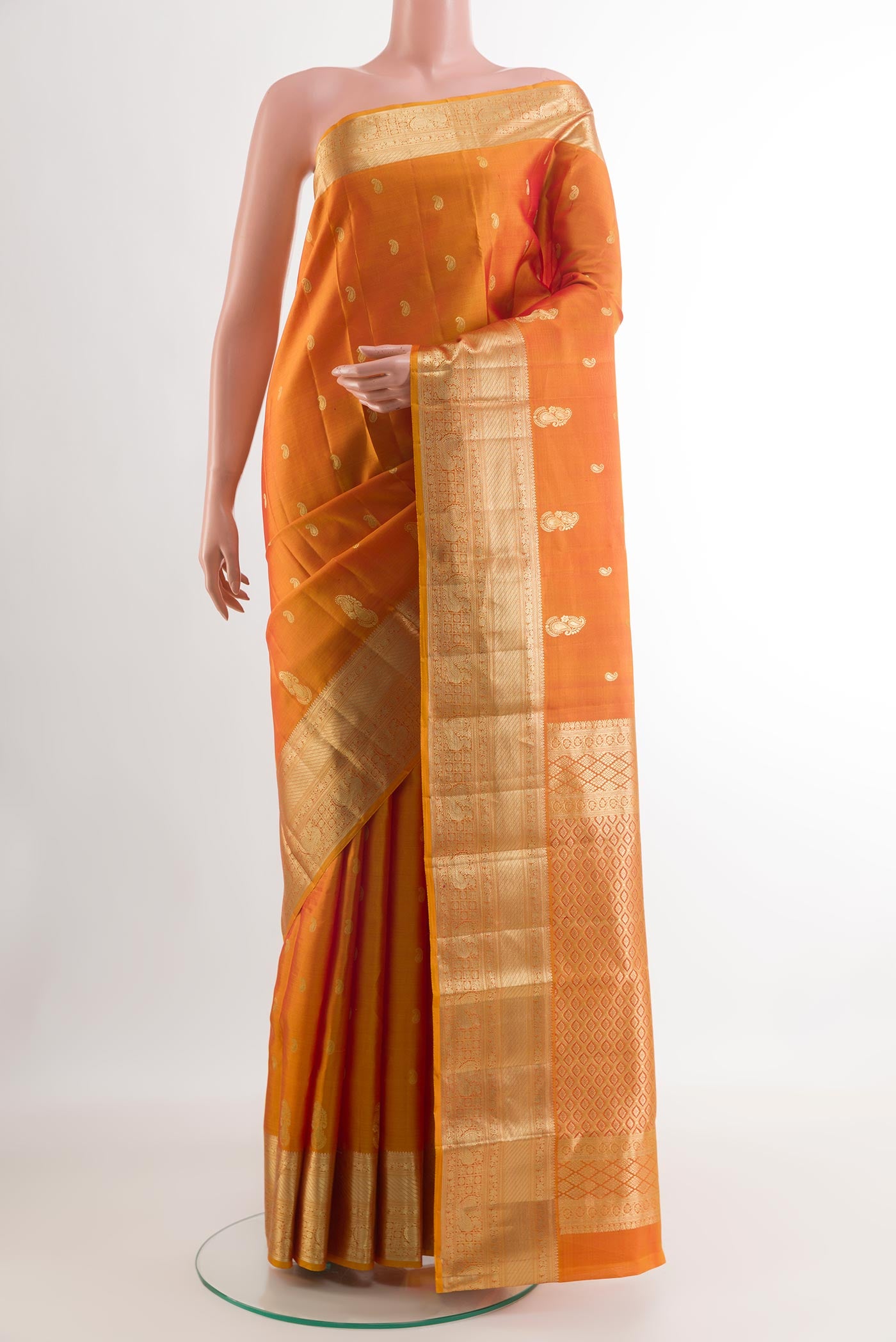 Yellow Kanjivaram Silk Saree with Zari Butta on the body and Zari Border.  displayed on a mannequin