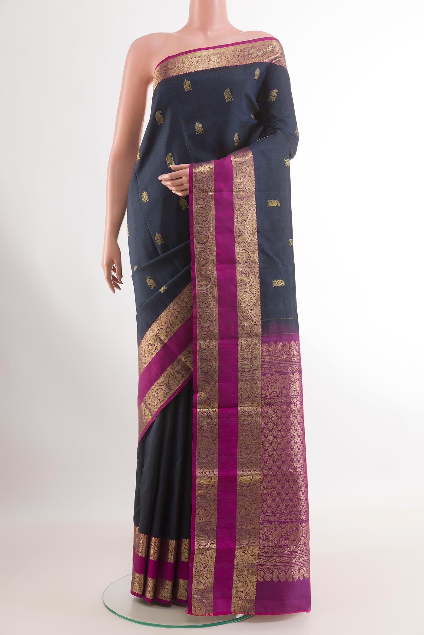 Dark Blue Kanchipuram Silk Saree with Zari Butta on the body and Zari Border.  displayed on a mannequin
