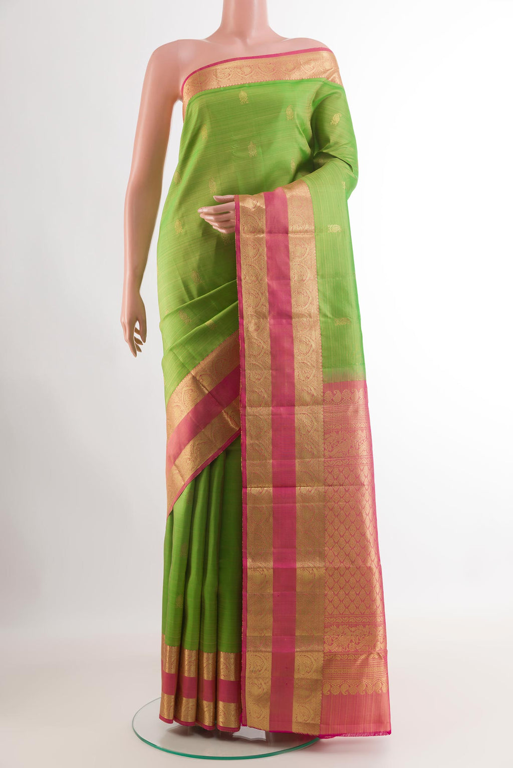 Green Kanchipuram Silk Saree with Zari Butta on the body and Zari Border.  displayed on a mannequin