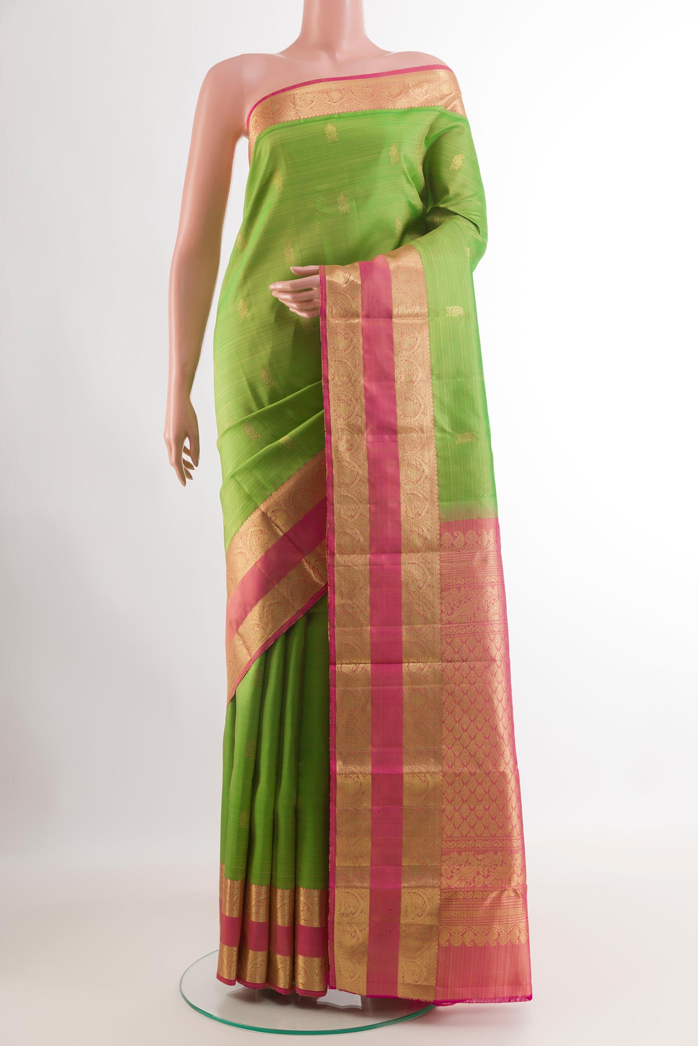 Green Kanchipuram Silk Saree with Zari Butta on the body and Zari Border.  displayed on a mannequin