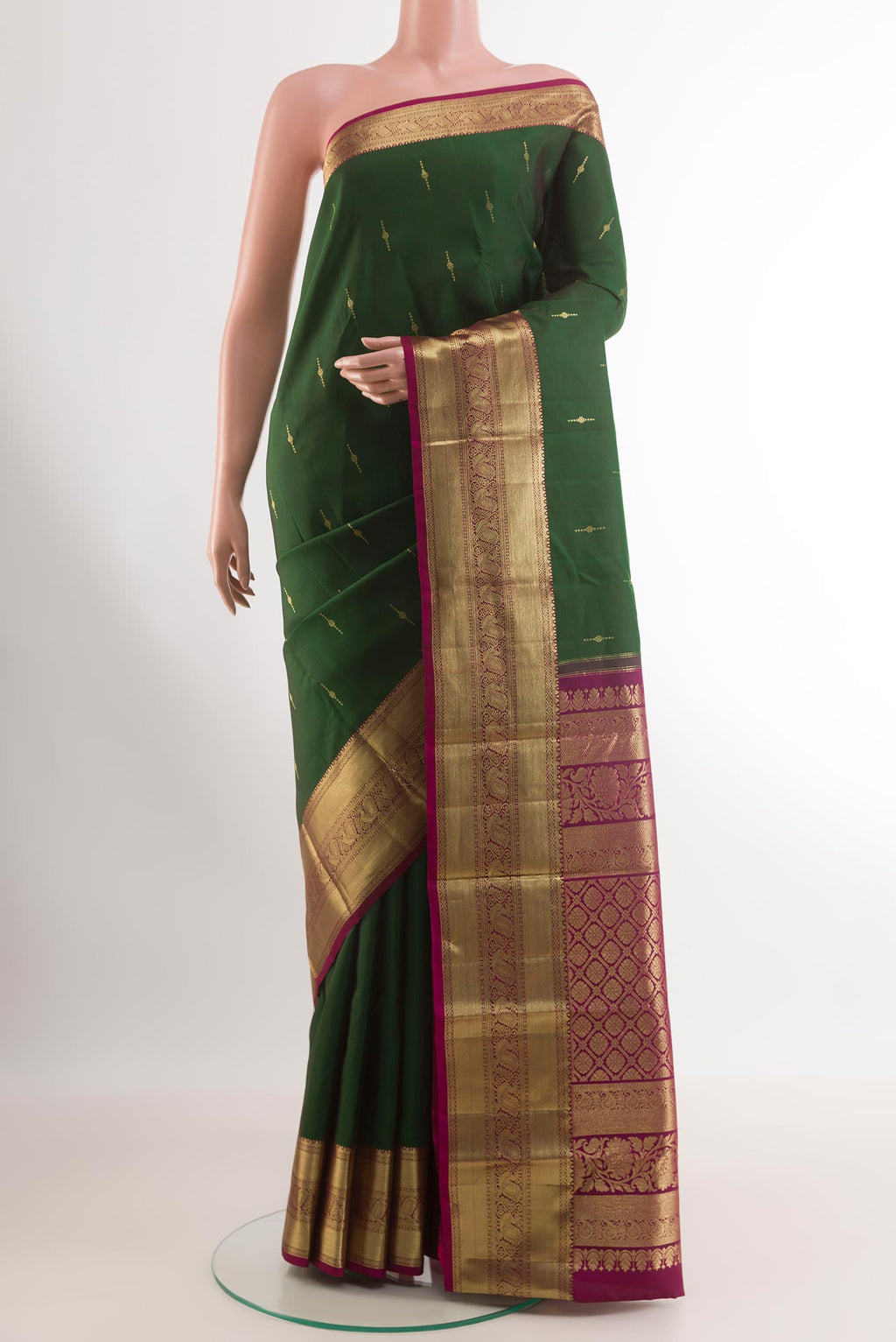 Green Kanchipuram Silk Saree with Zari Butta on the body and Zari Border.  displayed on a mannequin