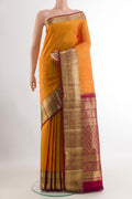 Mustard Kanchipuram Silk Saree with Zari Butta on the body and Zari Border.  displayed on a mannequin