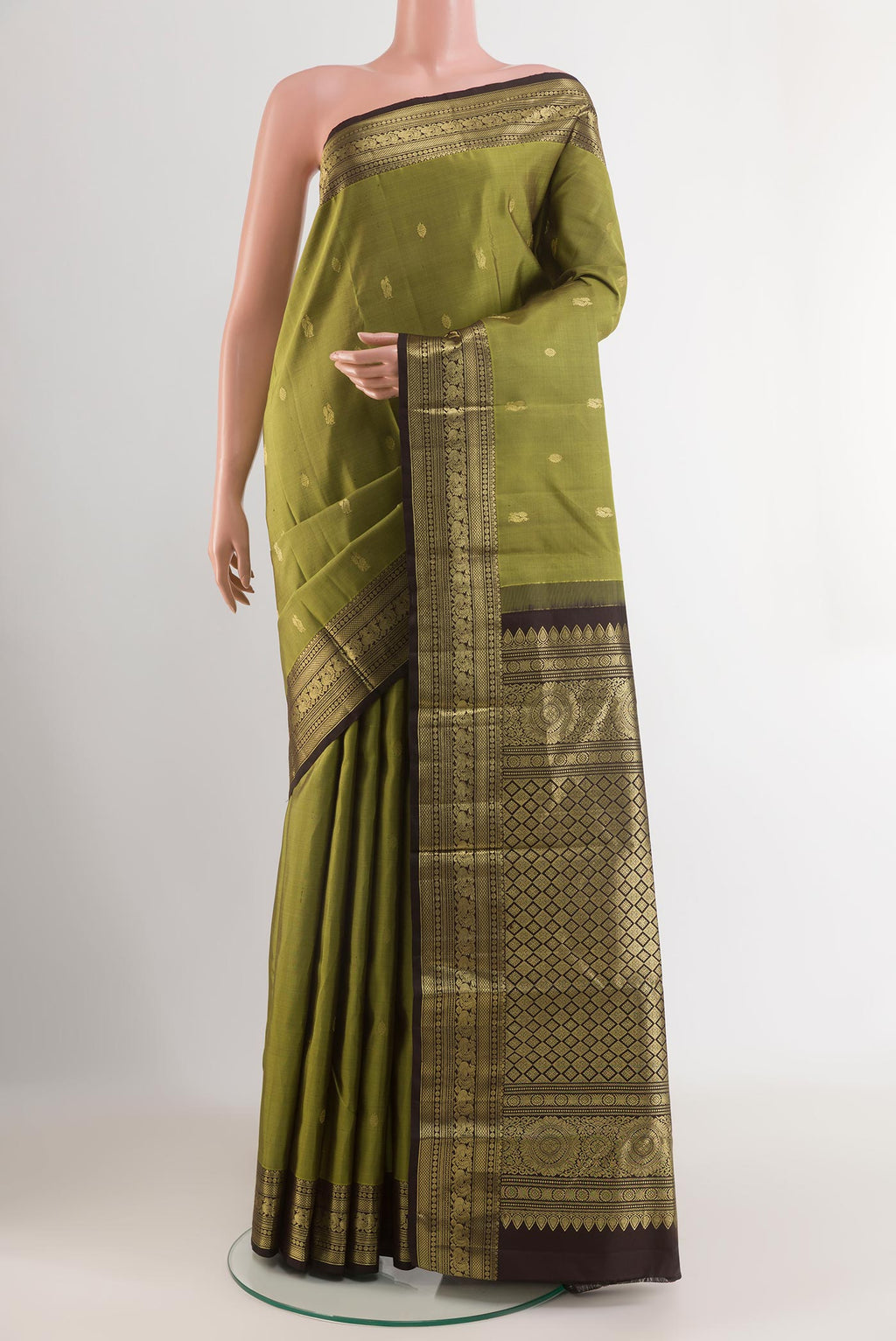 Green Kanchipuram Silk Saree with Zari Butta on the body and Zari Border.  displayed on a mannequin