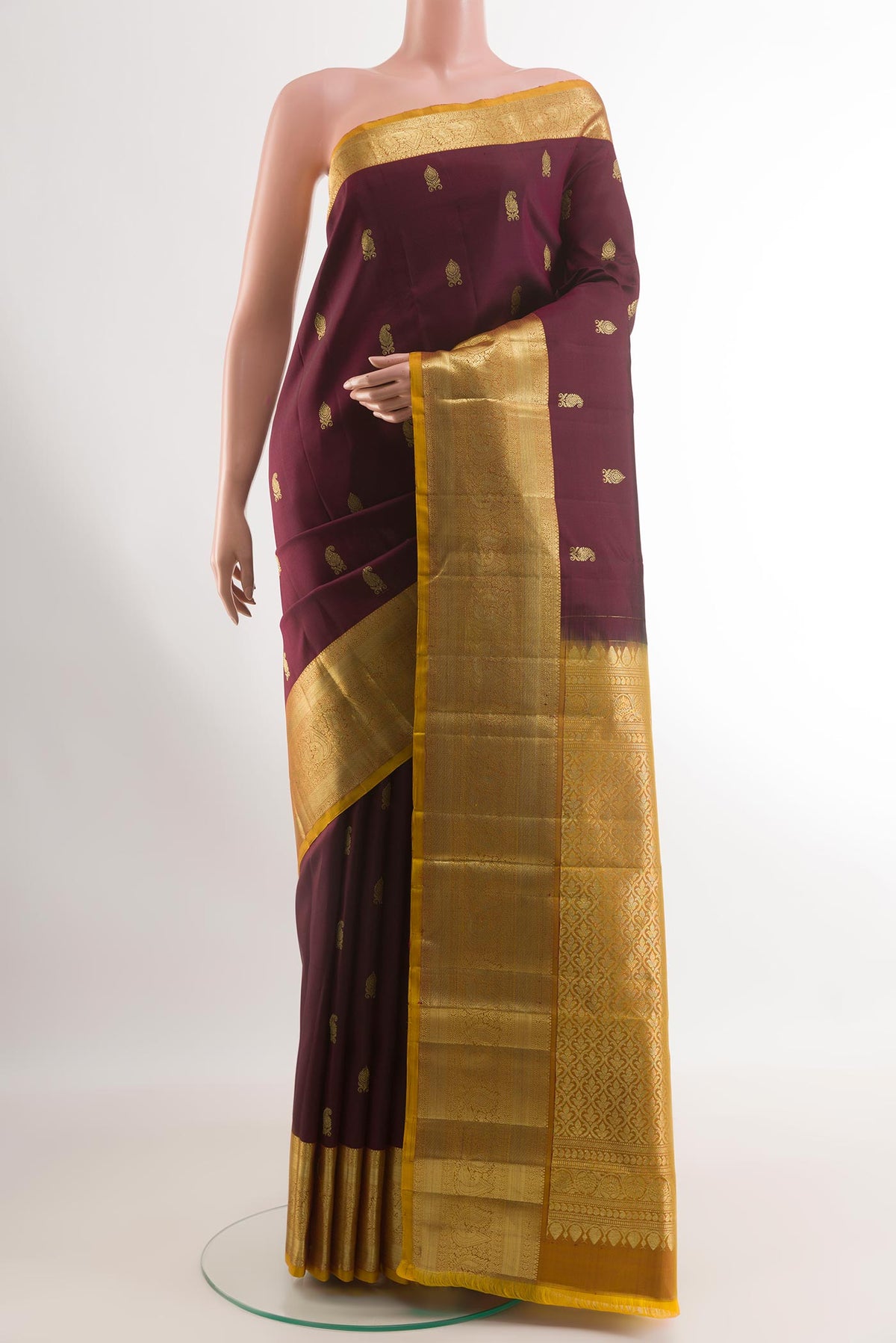 Purple Kanchipuram Silk Saree with Zari Butta on the body and Zari Border.  displayed on a mannequin