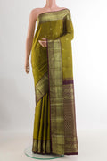 Mehandi Green Kanchipuram Silk Saree with Zari Butta on the body and Zari Border.  displayed on a mannequin