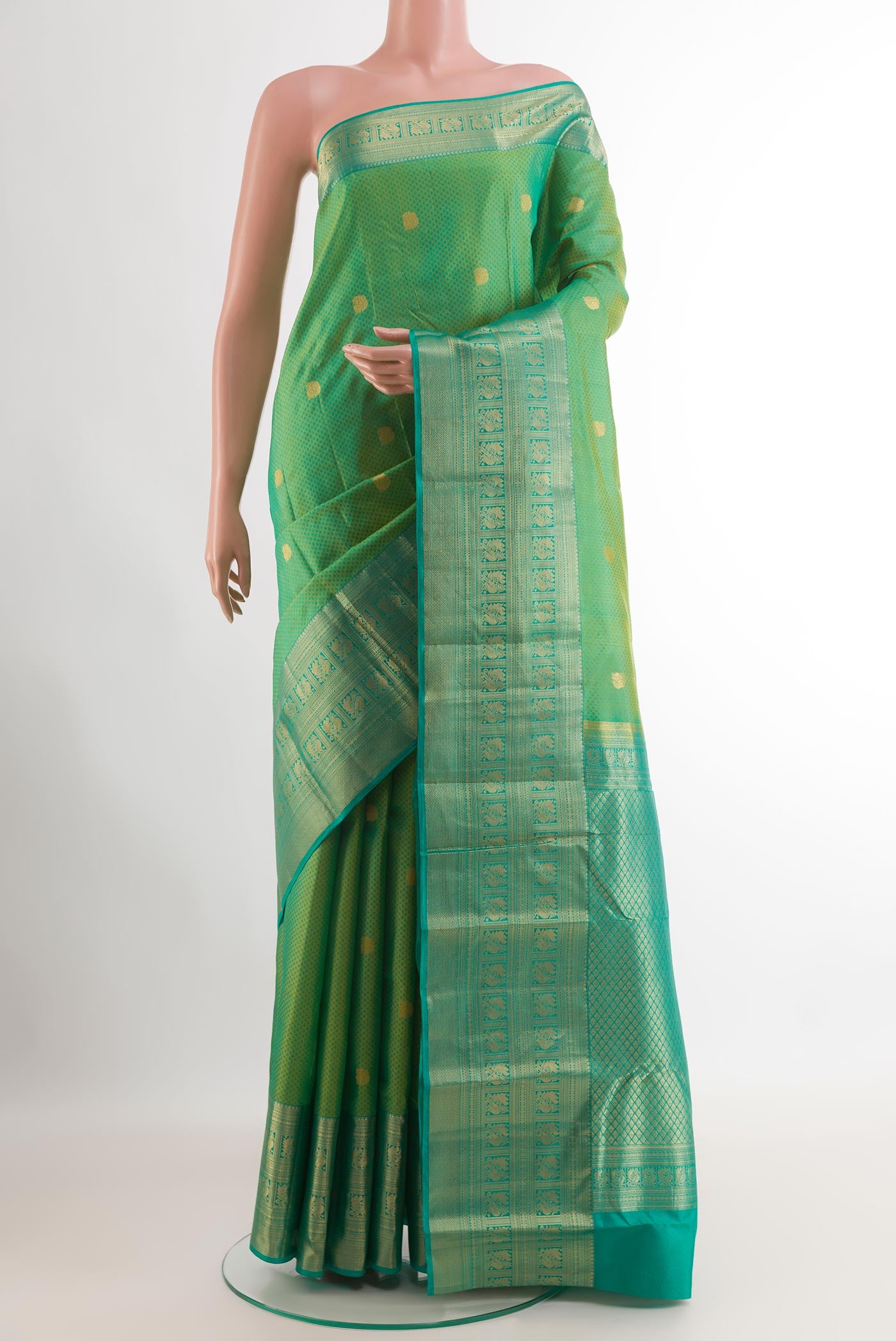 Green Kanchipuram Silk Saree with Jacquard With Zari Butta on the body and Zari Border.  displayed on a mannequin
