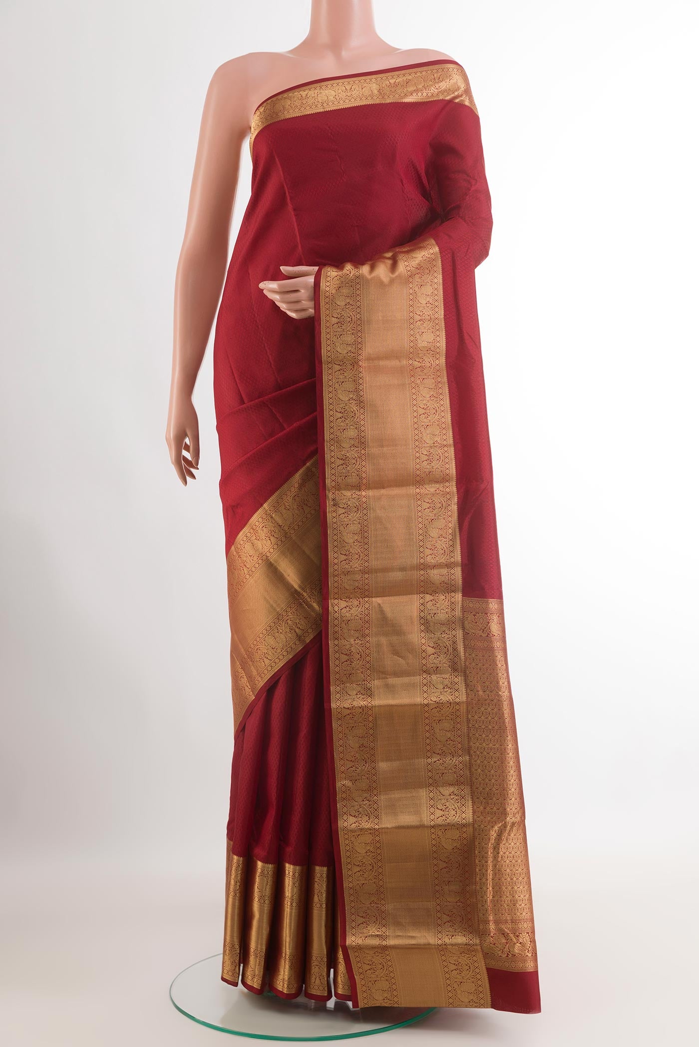 Maroon Kanchipuram Silk Saree with Jacquard design on the body and Zari Border.  displayed on a mannequin