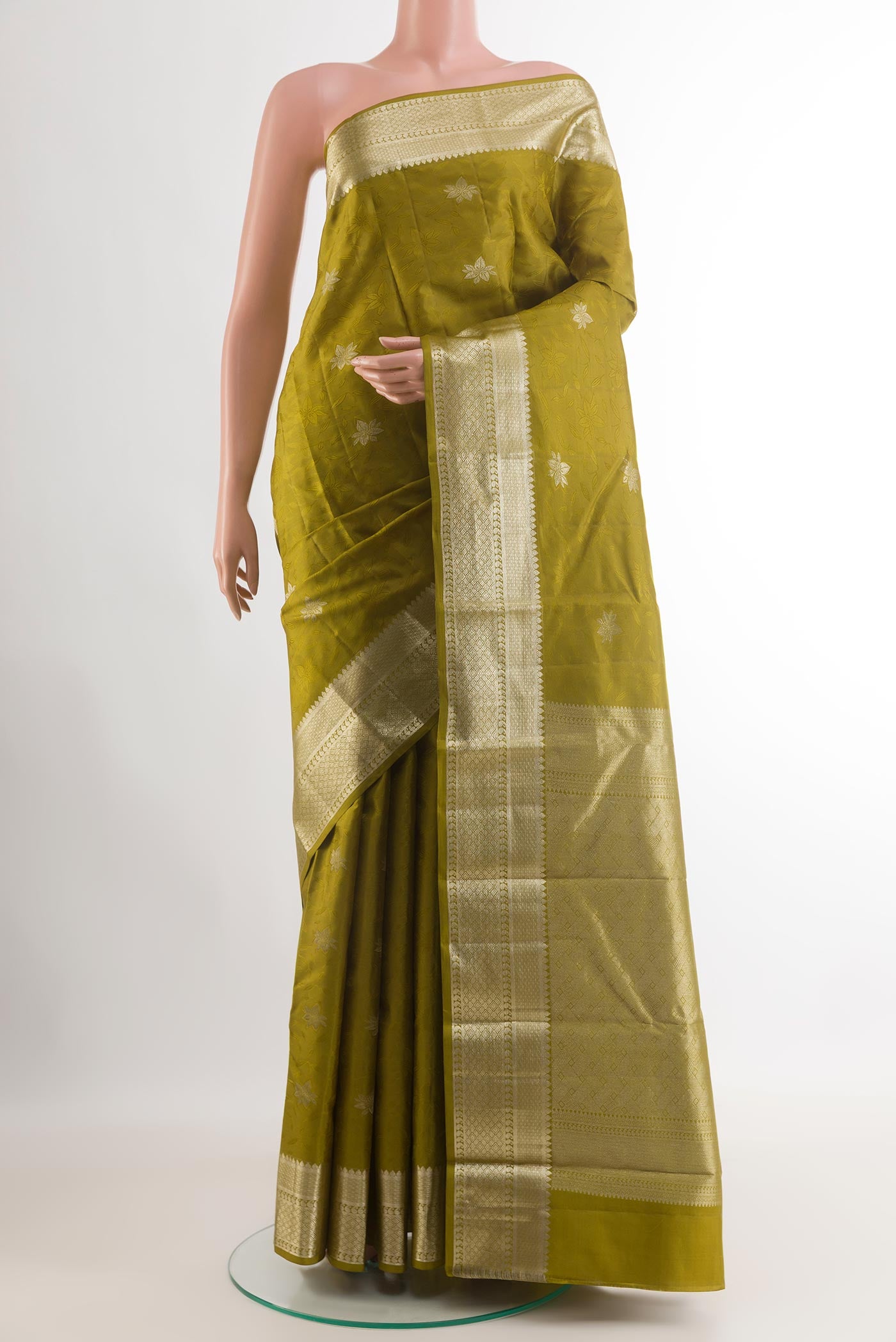 Mehandi Green Kanchipuram Silk Saree with Jacquard design on the body and Zari Border.  displayed on a mannequin