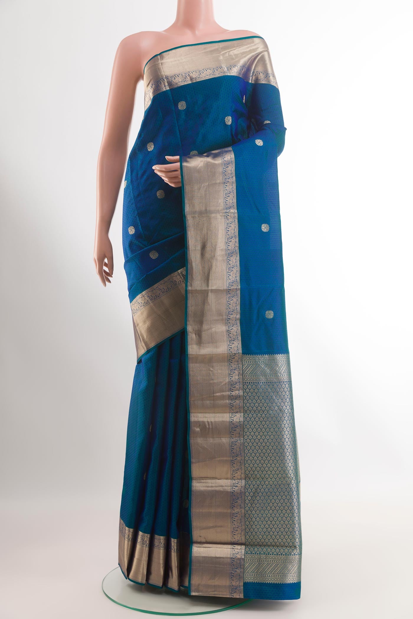 Peacock Blue Kanchipuram Silk Saree with Jacquard With Zari Butta on the body and Zari Border.  displayed on a mannequin
