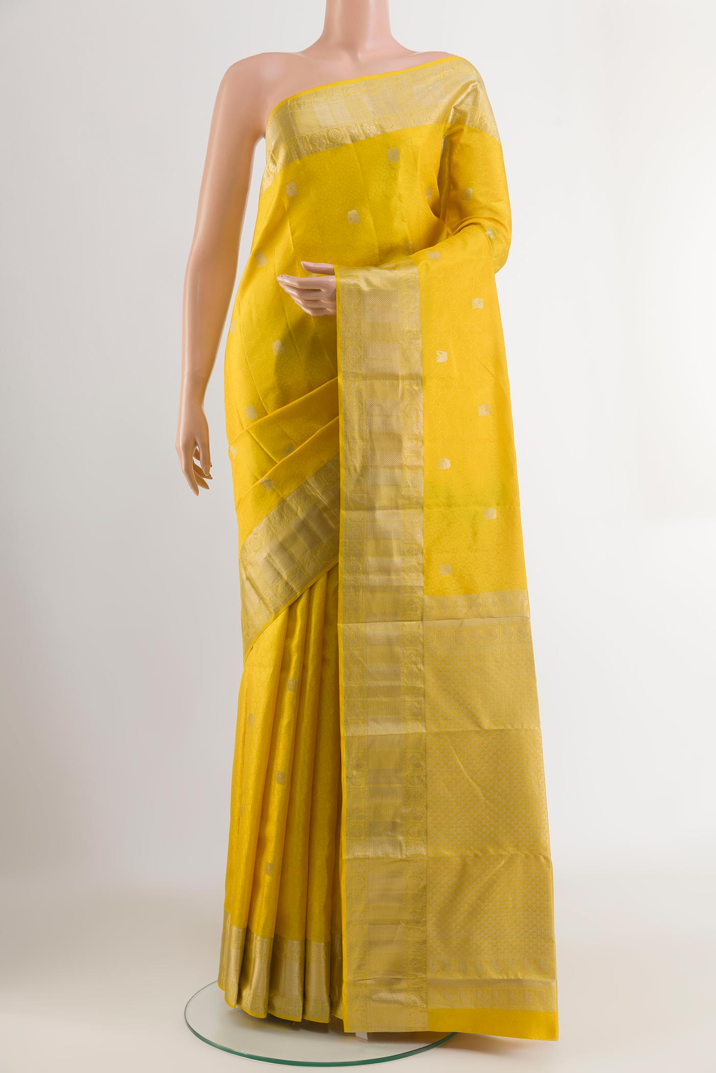 Yellow Kanchipuram Silk Saree with Jacquard With Zari Butta on the body and Zari Border.  displayed on a mannequin