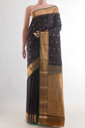 Pure Silk Black Kanjivaram Saree with Zari Butta on the body and Zari Border.  displayed on a mannequin