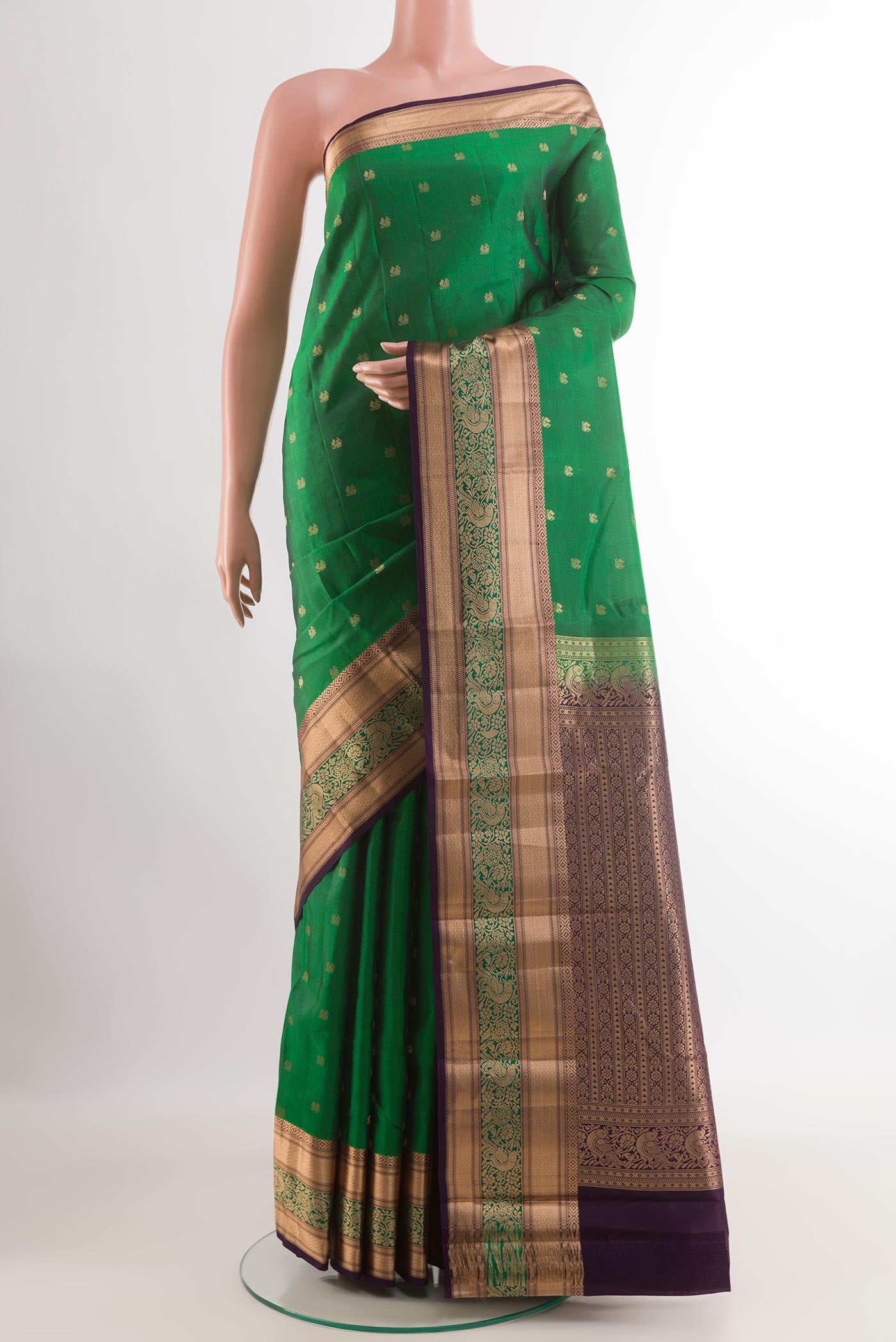 Green Kanjivaram Silk Saree with Zari Butta on the body and Zari Border.  displayed on a mannequin