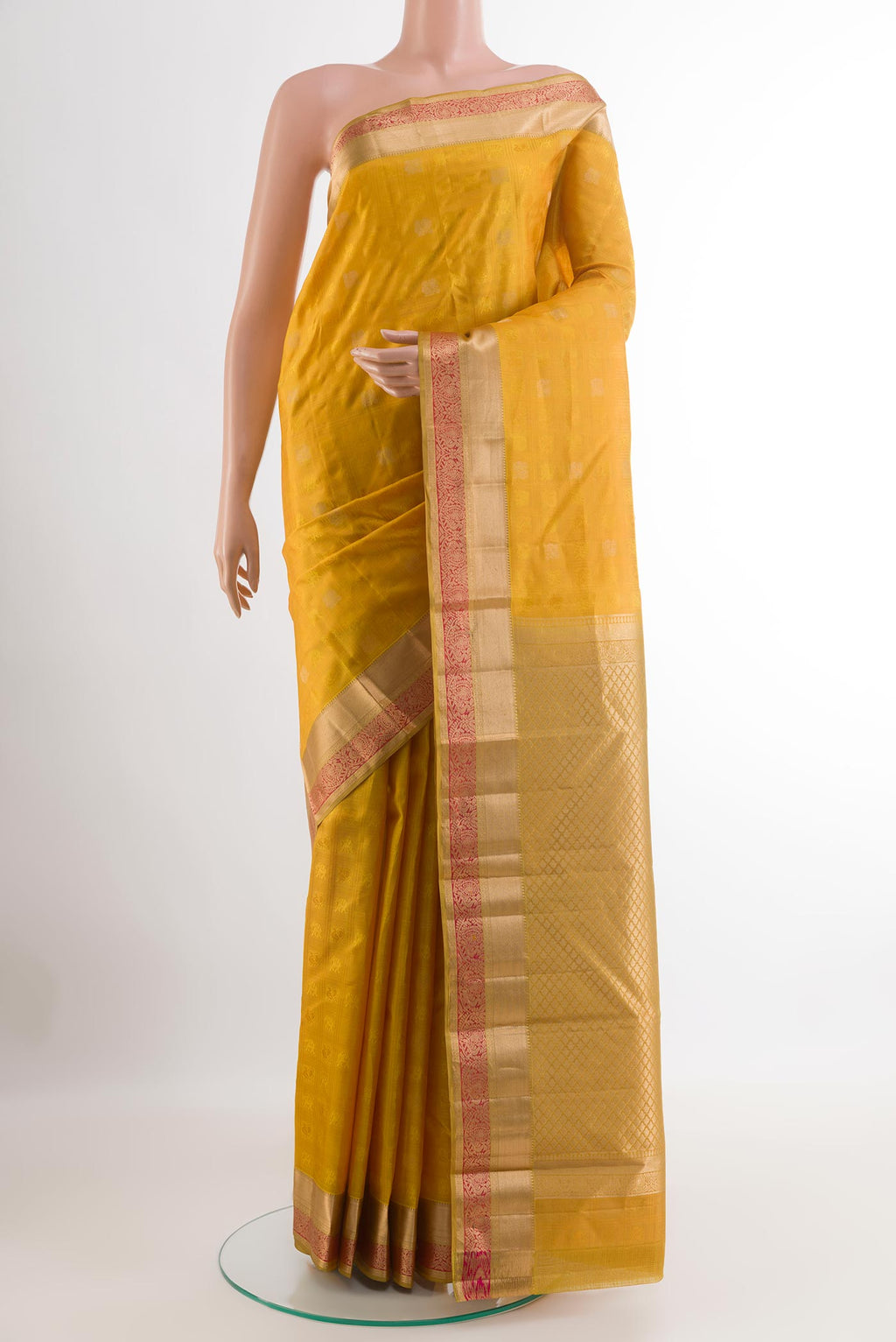 Yellow Kanjivaram Silk Saree with Jacquard design on the body and Zari Border.  displayed on a mannequin
