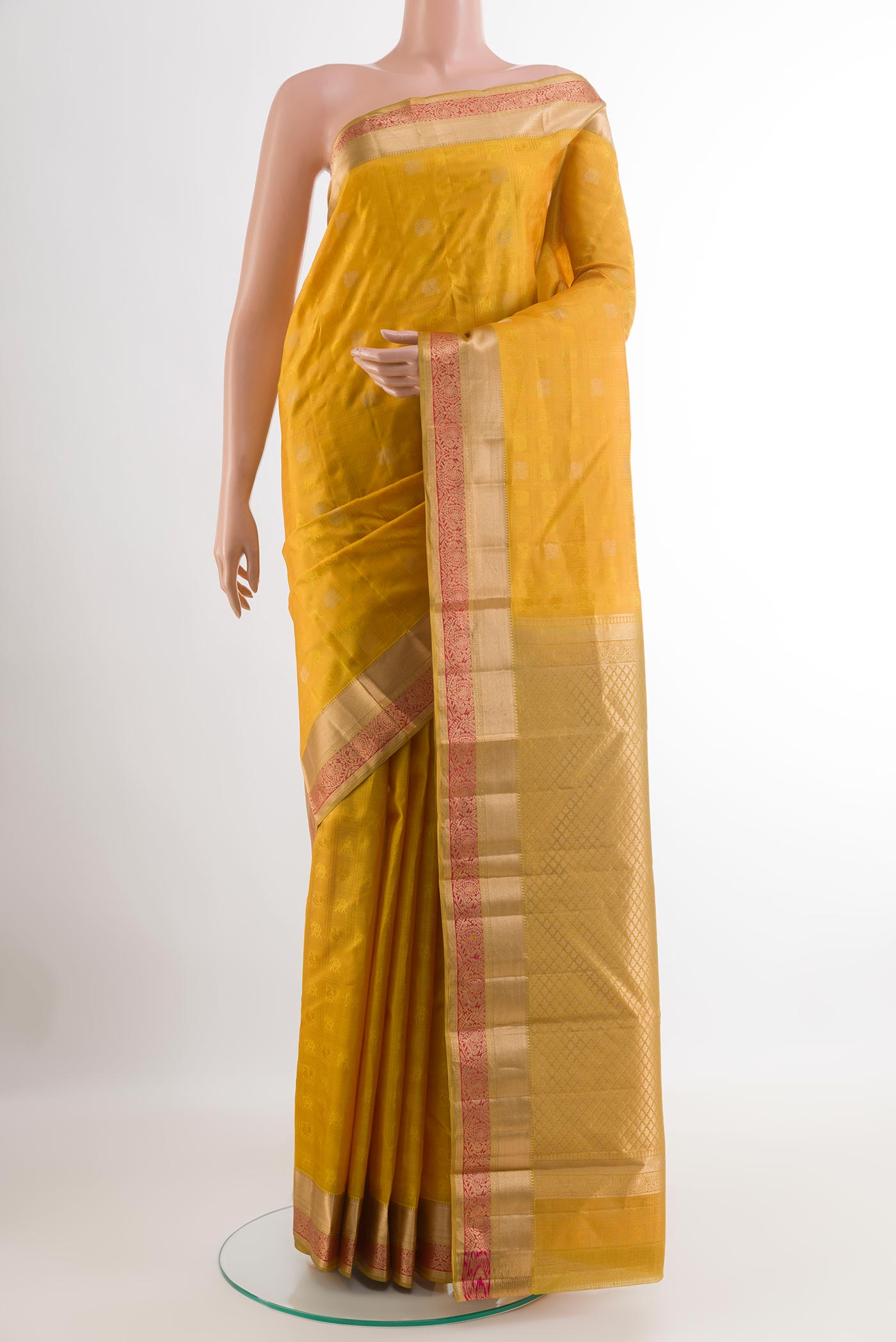 Yellow Kanjivaram Silk Saree with Jacquard design on the body and Zari Border.  displayed on a mannequin
