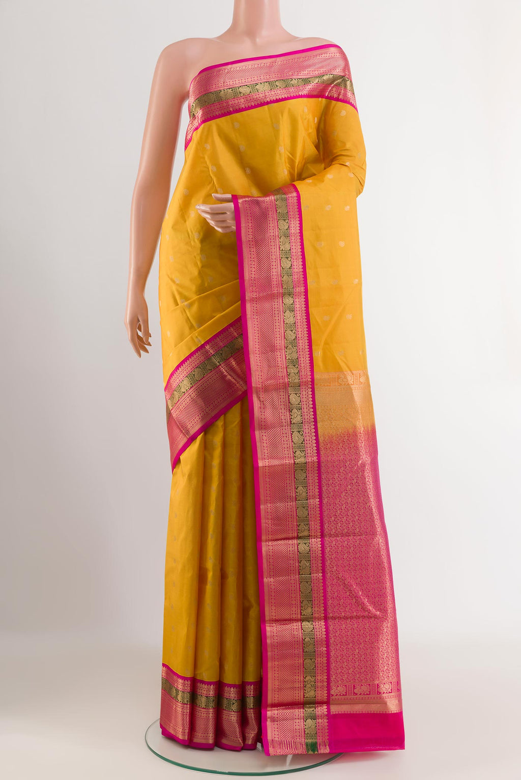 Yellow Kanchipuram Silk Saree with Zari Butta on the body and Zari Border.  displayed on a mannequin