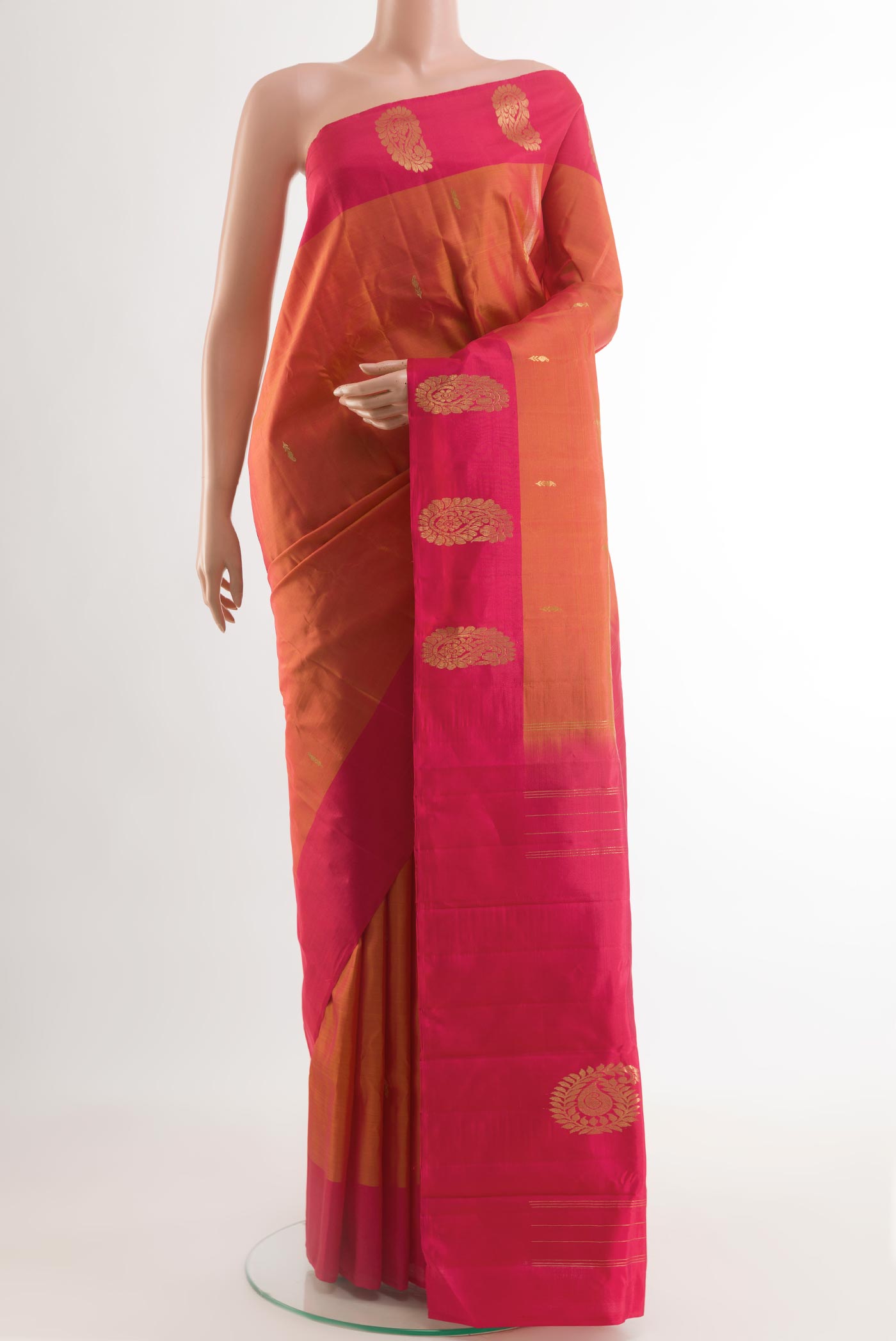 Brick Orange Kanchipuram Silk Saree with Zari Butta on the body and Zari Border.  displayed on a mannequin