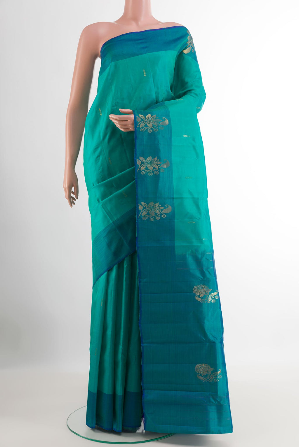 Sea Green Kanchipuram Silk Saree with Zari Butta on the body and Zari Border.  displayed on a mannequin