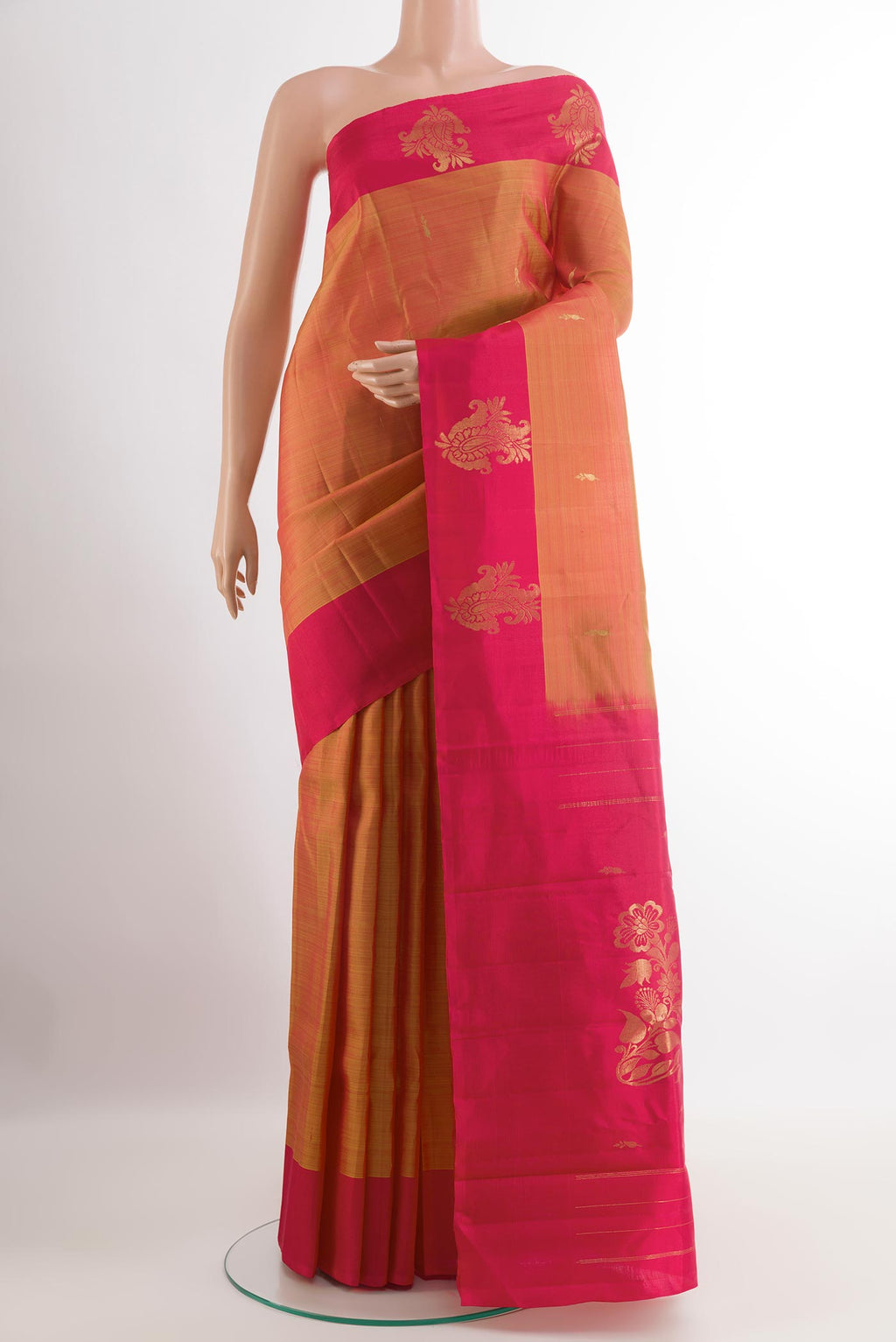 Brick Orange Kanchipuram Silk Saree with Zari Butta on the body and Zari Border.  displayed on a mannequin