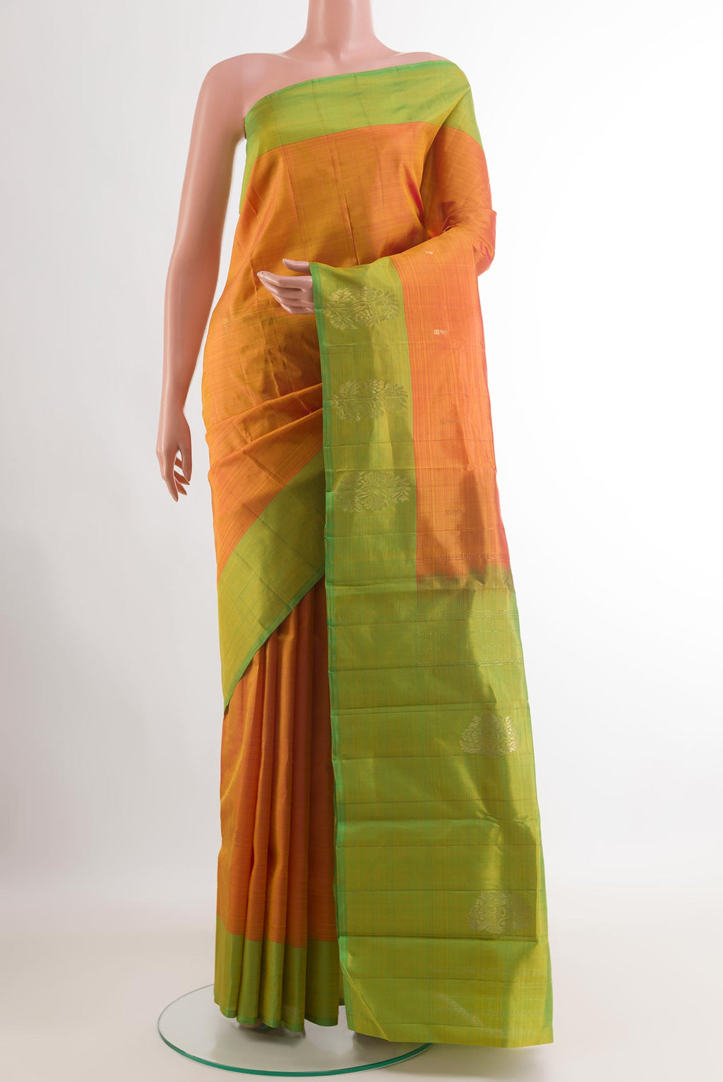 Orange Kanchipuram Silk Saree with Zari Butta on the body and Zari Border.  displayed on a mannequin