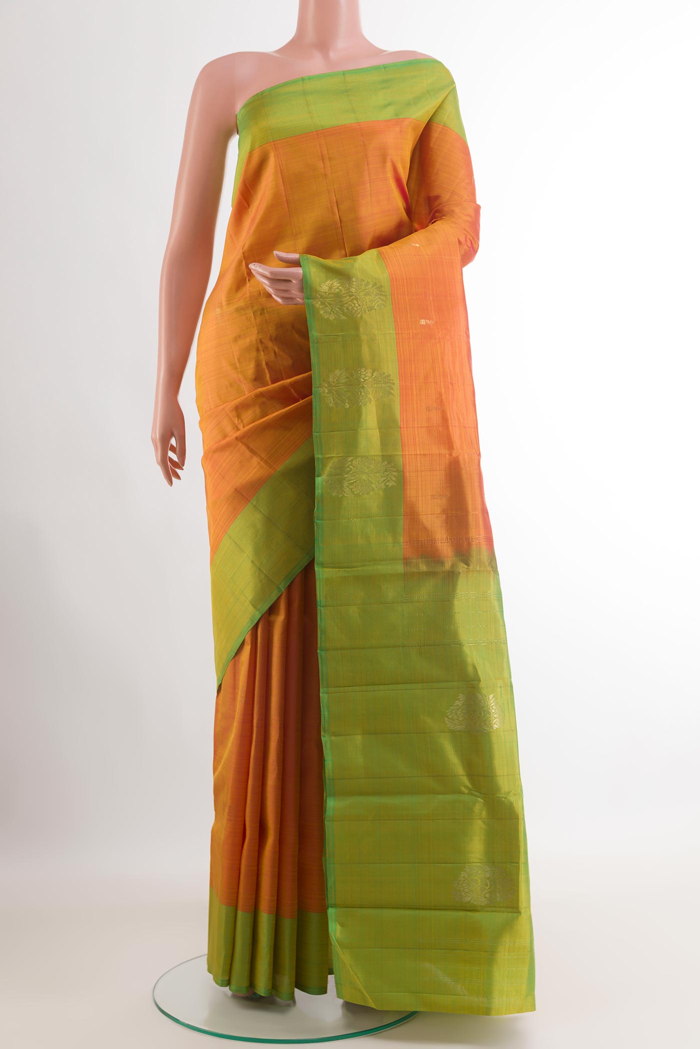Orange Kanchipuram Silk Saree with Zari Butta on the body and Zari Border.  displayed on a mannequin