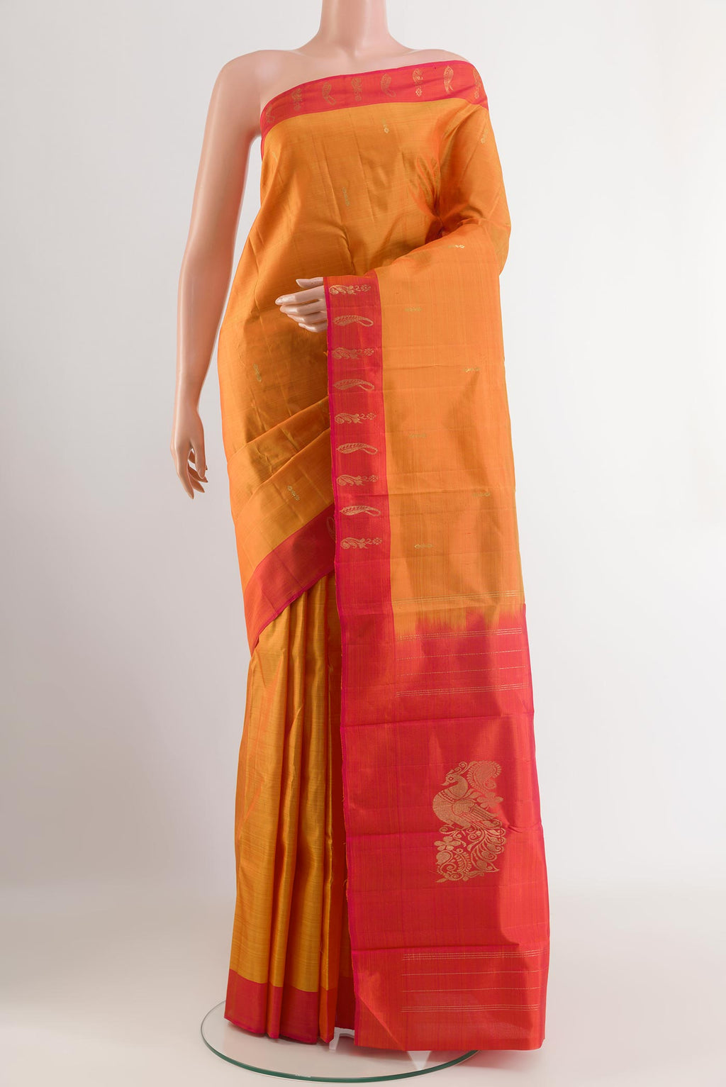 Orange Kanchipuram Silk Saree with Zari Butta on the body and Zari Border.  displayed on a mannequin