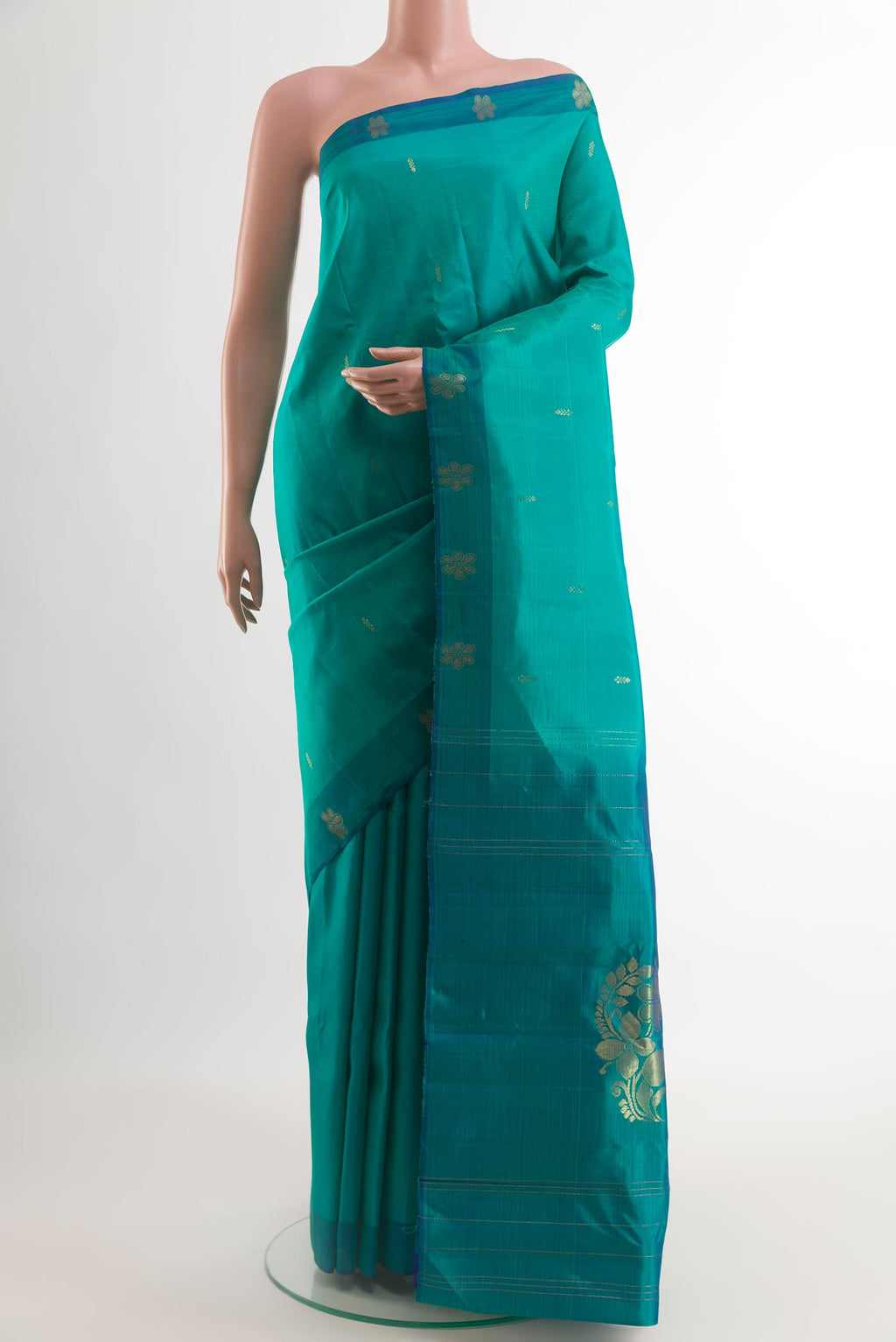 Sea Green Kanchipuram Silk Saree with Zari Butta on the body and Zari Border.  displayed on a mannequin