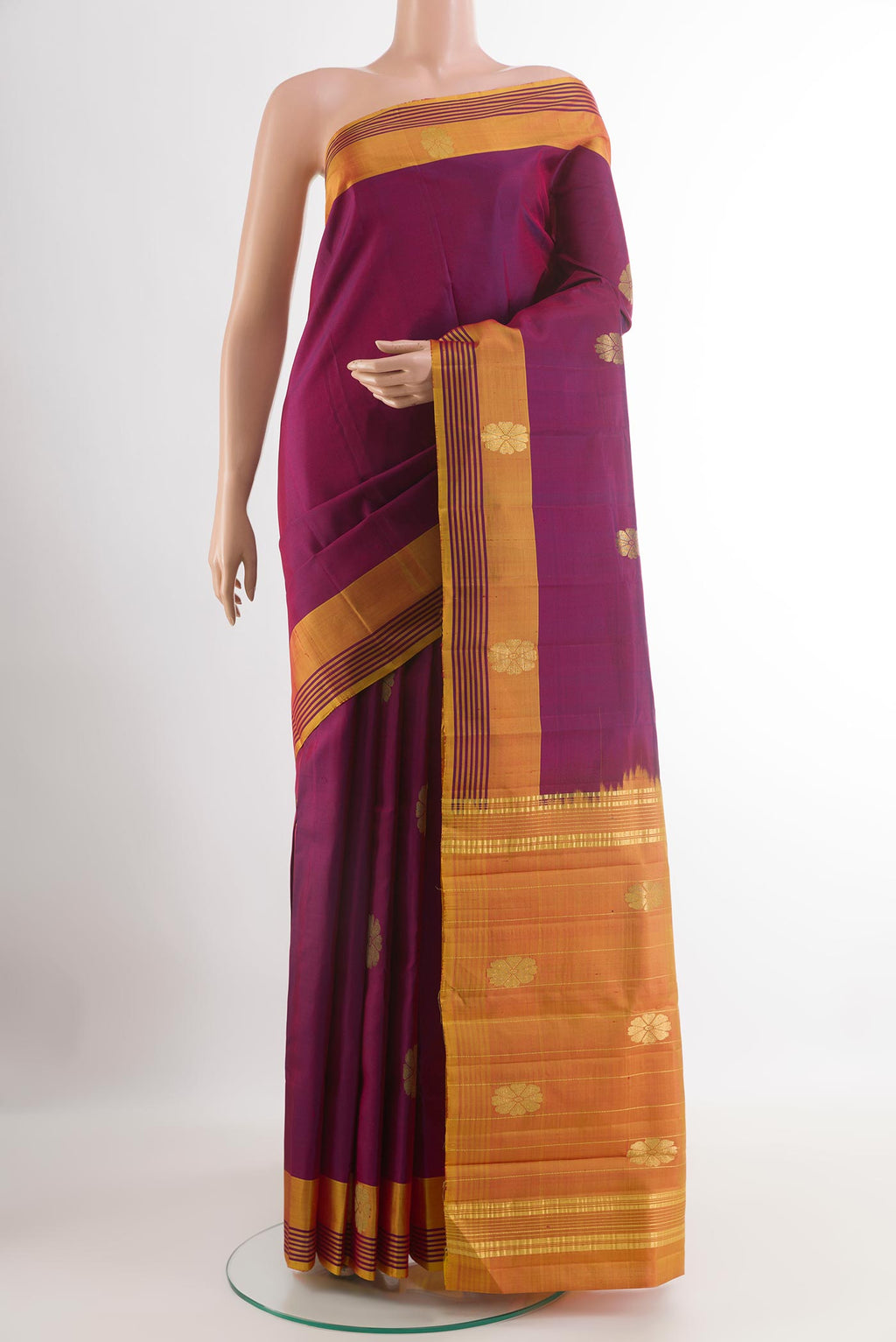 Purple Kanchipuram Silk Saree with Zari Butta on the body and Zari Border.  displayed on a mannequin