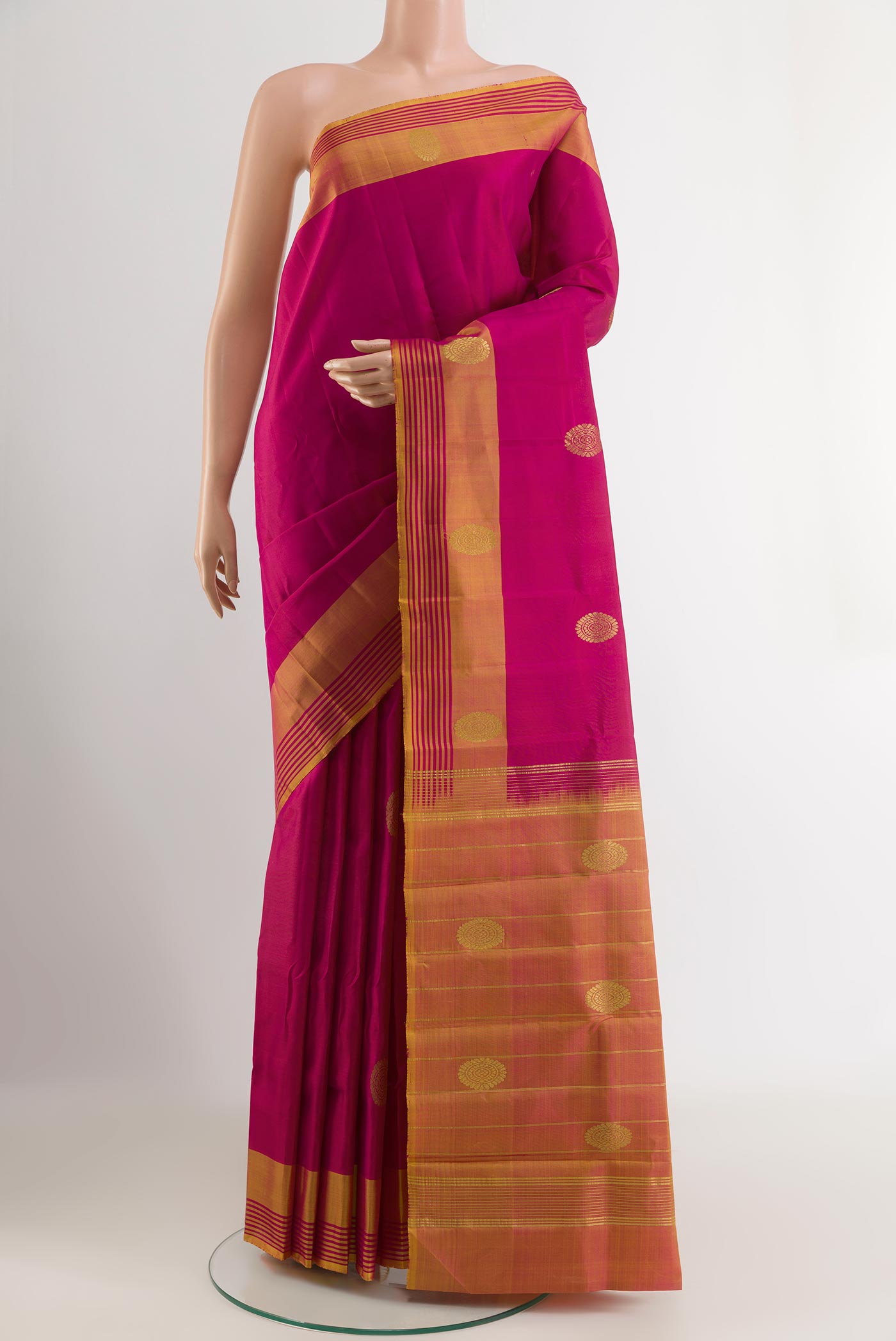 Pink Kanchipuram Silk Saree with Zari Butta on the body and Zari Border.  displayed on a mannequin