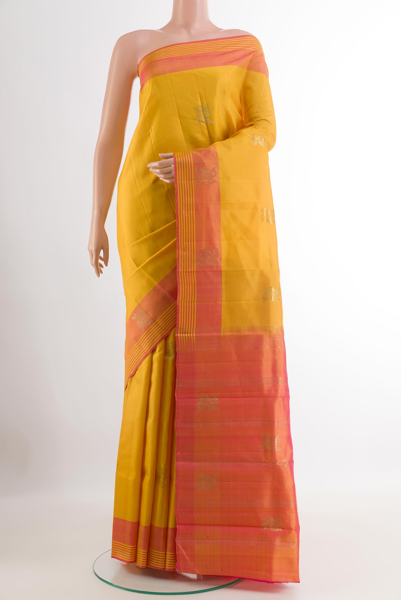 Yellow Kanchipuram Silk Saree with Zari Butta on the body and Zari Border.  displayed on a mannequin