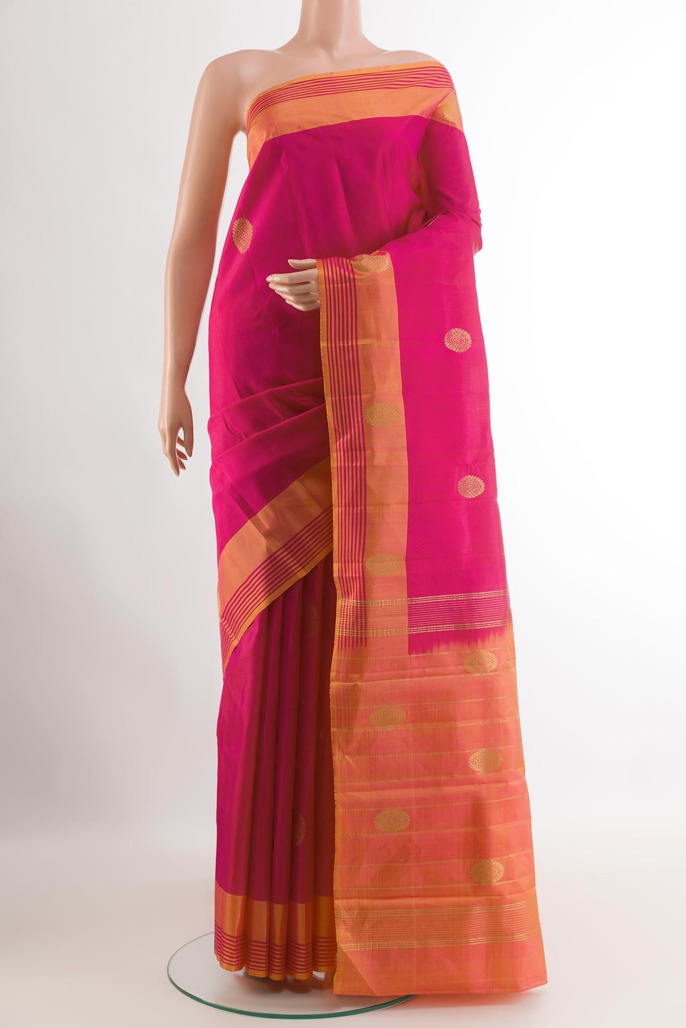 Pink Kanchipuram Silk Saree with Zari Butta on the body and Zari Border.  displayed on a mannequin