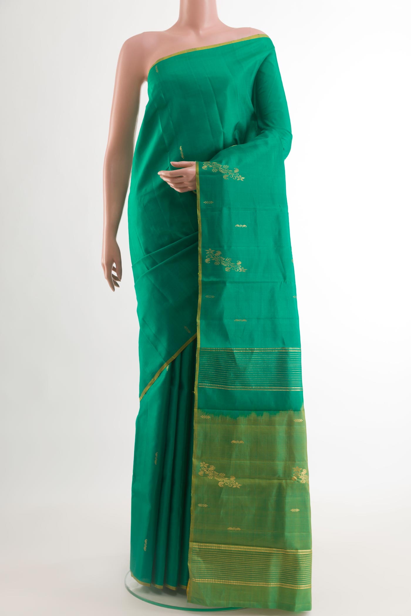 Green Kanchipuram Silk Saree with Zari Butta on the body and Zari Border.  displayed on a mannequin