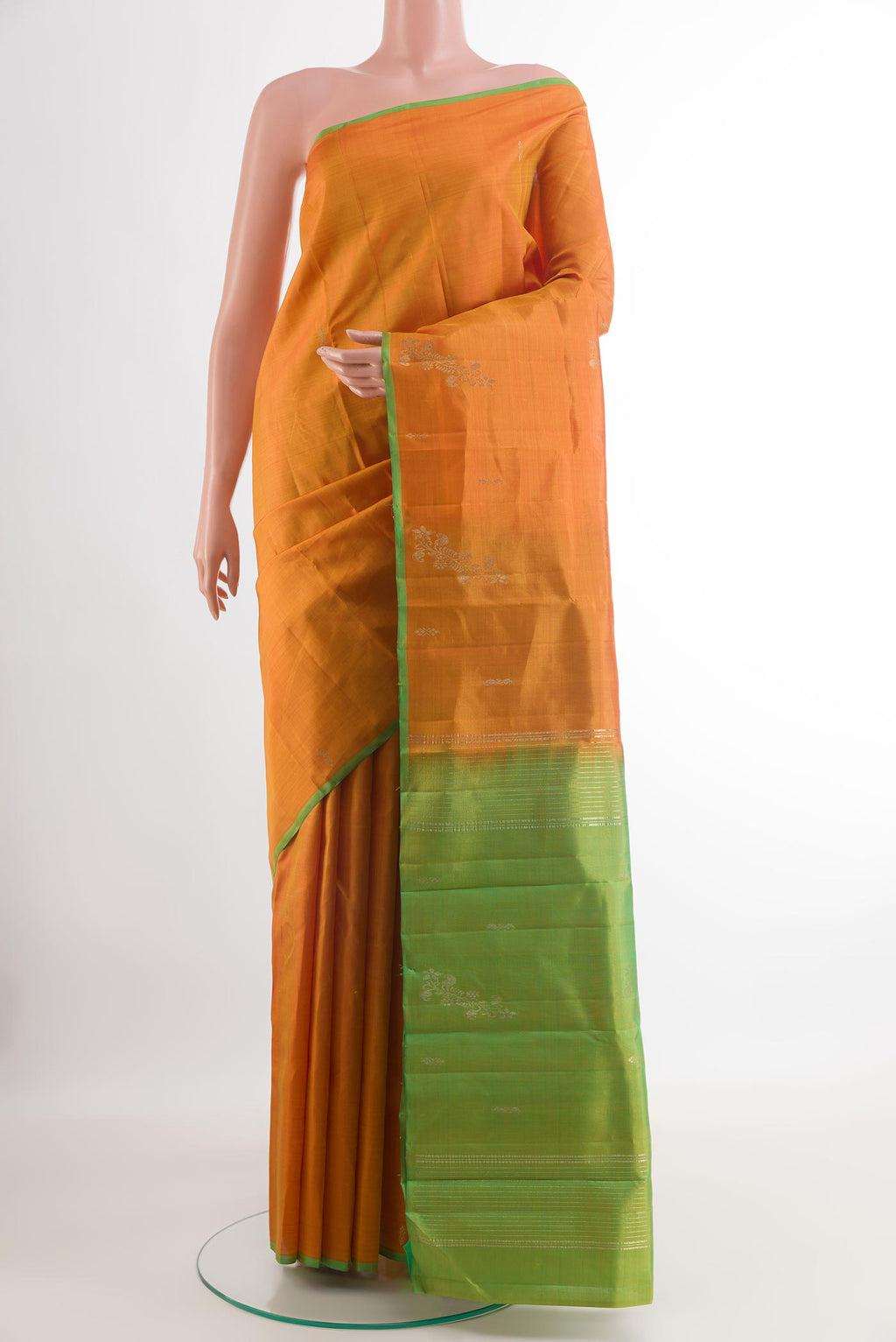 Orange Kanchipuram Silk Saree with Zari Butta on the body and Zari Border.  displayed on a mannequin