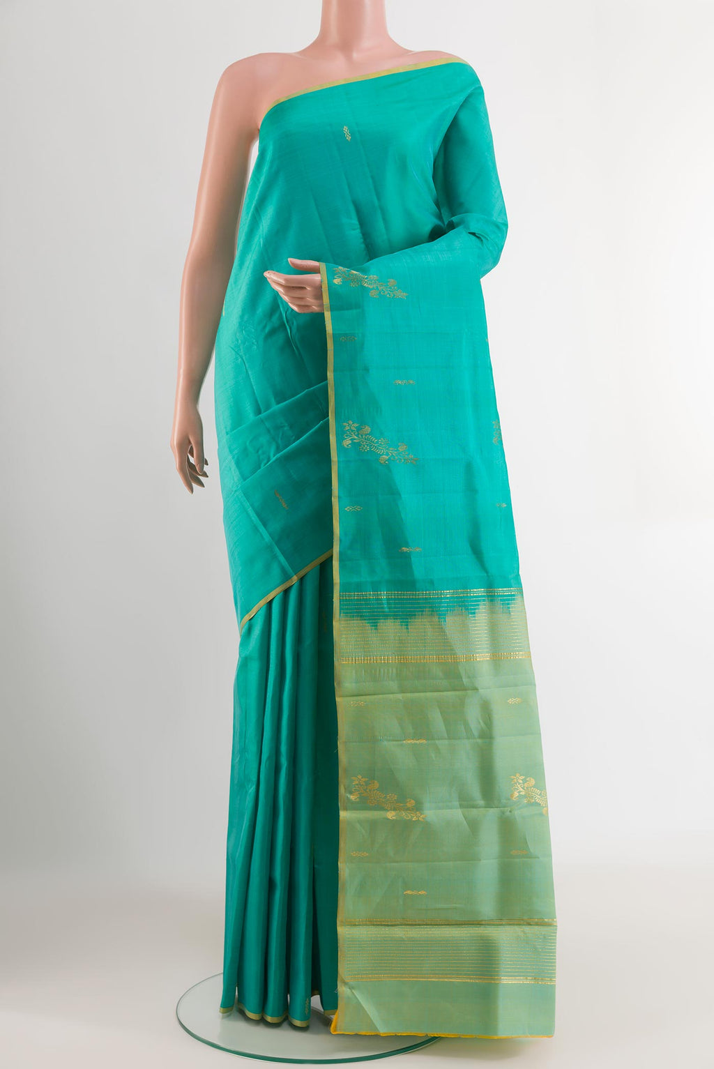 Blue Kanchipuram Silk Saree with Zari Butta on the body and Zari Border.  displayed on a mannequin