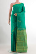 Green Kanchipuram Silk Saree with Zari Butta on the body and Zari Border.  displayed on a mannequin