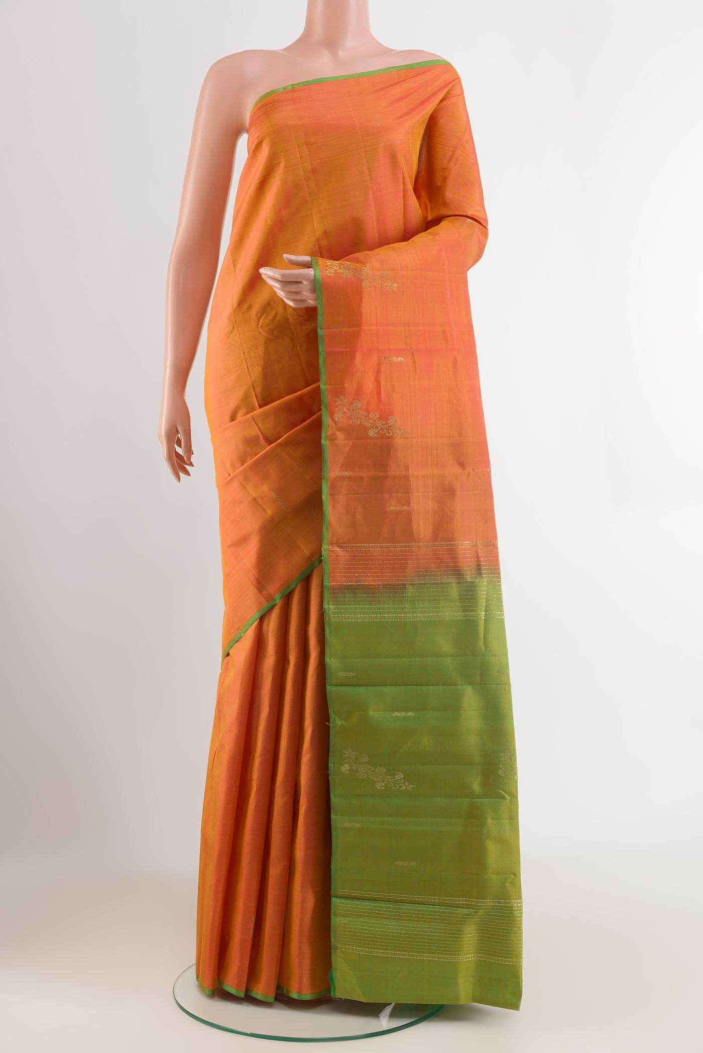 Orange Kanchipuram Silk Saree with Zari Butta on the body and Zari Border.  displayed on a mannequin