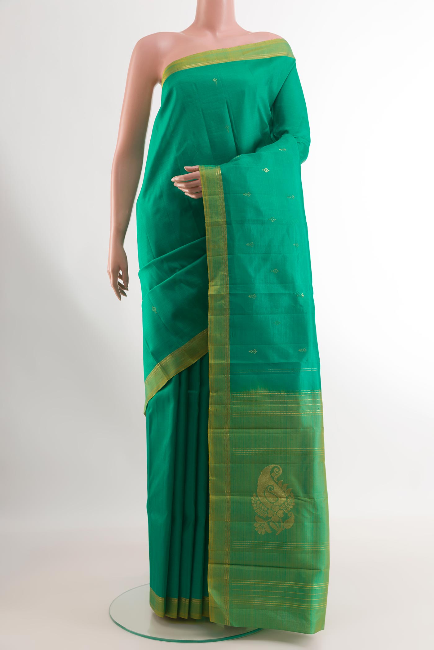Green Kanchipuram Silk Saree with Zari Butta on the body and Zari Border.  displayed on a mannequin