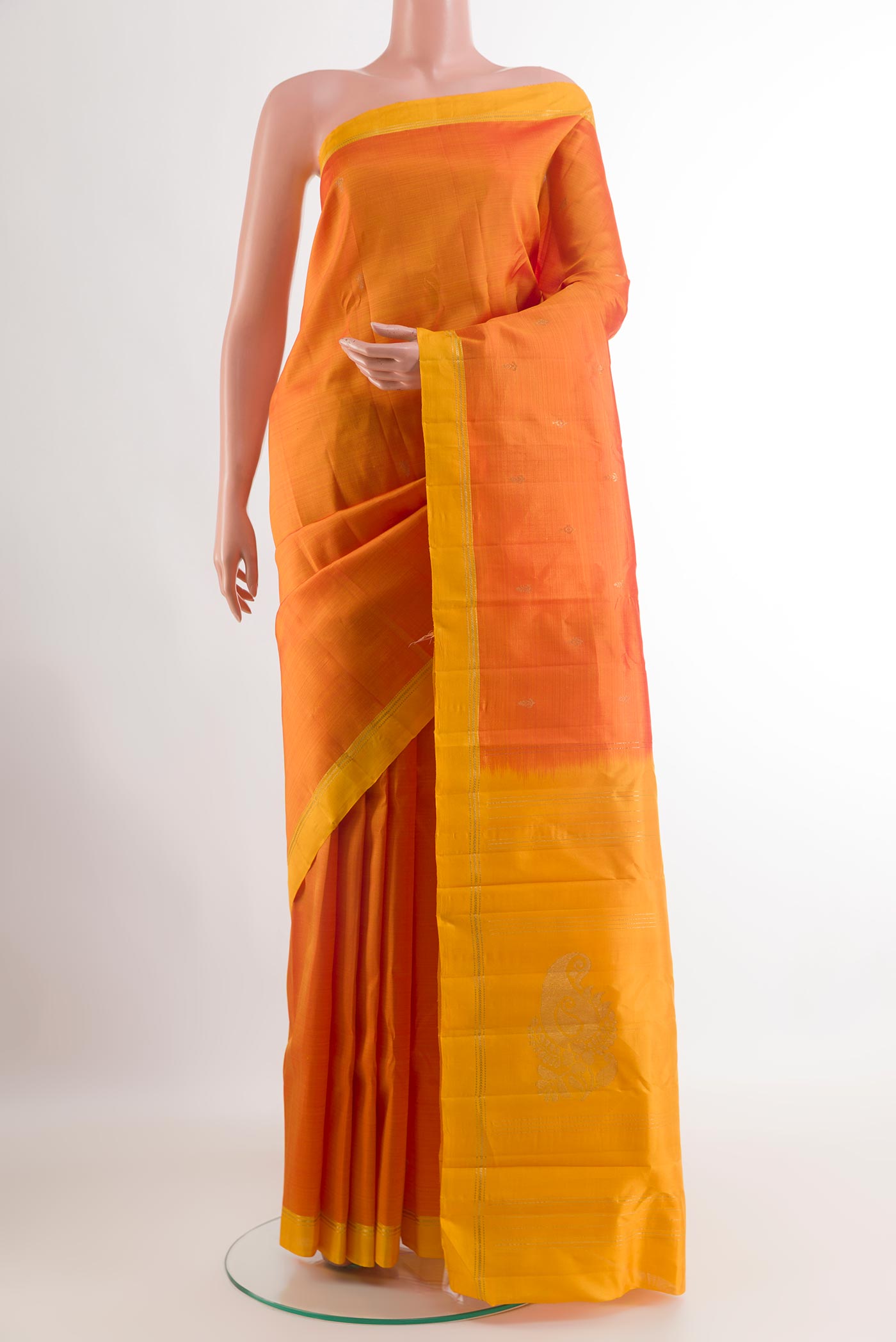 Orange Kanchipuram Silk Saree with Zari Butta on the body and Zari Border.  displayed on a mannequin
